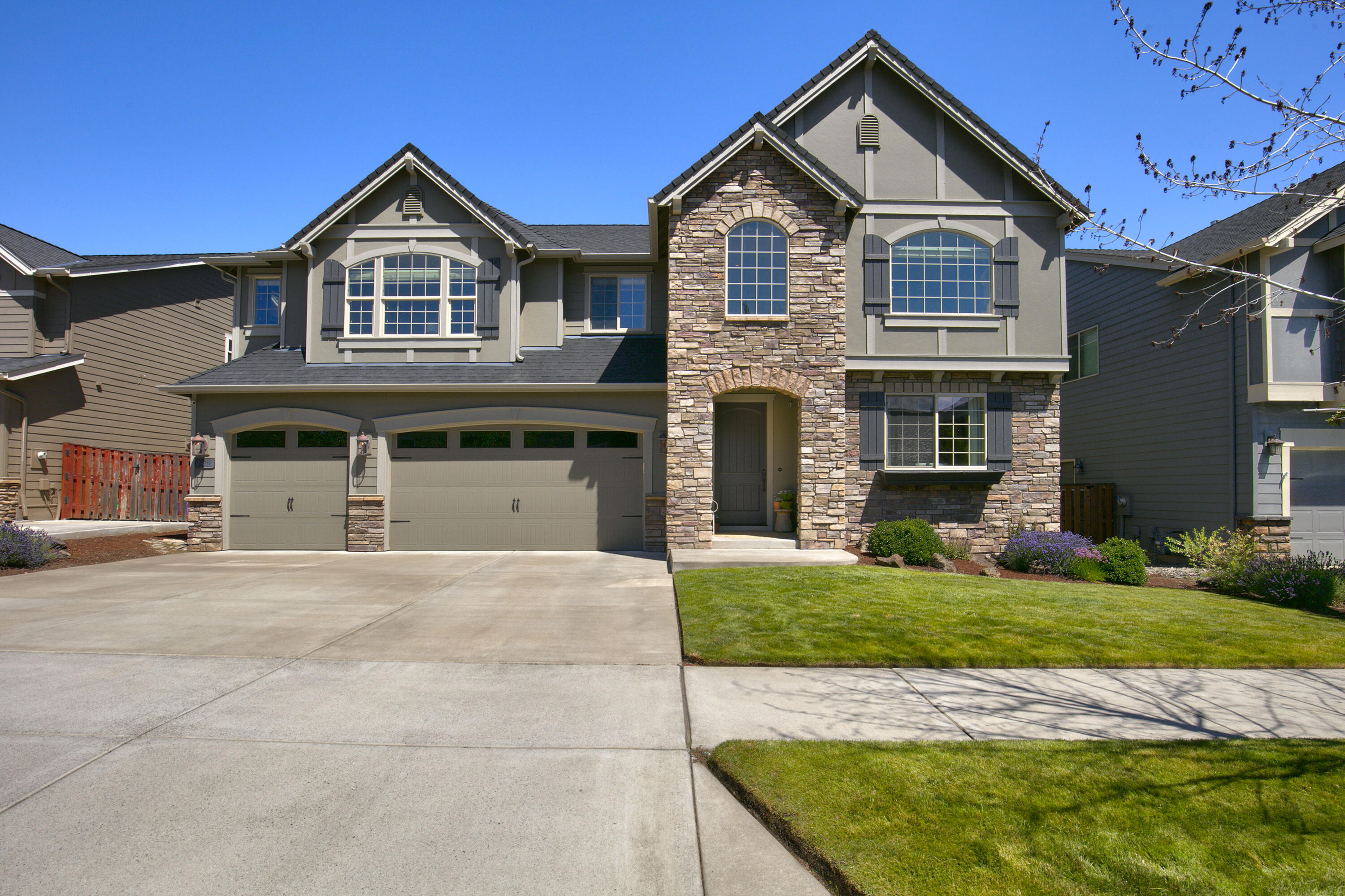 Welcome to your dream home in one of Bend's most desirable neighborhoods! This 3,465 sq ft, 5-bedroom home on a 6,098 sq ft lot offers the perfect mix of space, comfort, and versatility. The main level includes a guest suite and dedicated office, while upstairs features a large bonus room and additional bedrooms. Enjoy hardwood floors, a spacious kitchen with eating bar, stainless appliances, and a walk-in pantry. The two-story great room flows to a fully fenced backyard with a covered patio—ideal for outdoor living. The generous upstairs primary suite boasts an updated bath with a freestanding tub, full tile shower, dual sinks, and a large walk-in closet. A 3-car garage adds storage and convenience. Located in Sun Meadow with access to a community pool, playground, and close to Alpenglow Park and schools.