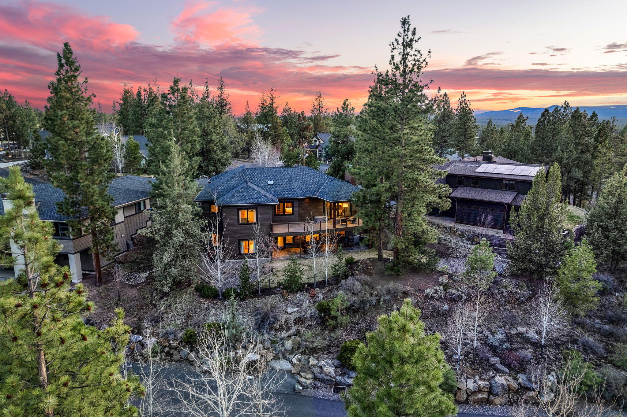 Inspired by midcentury modern design, this Certified Platinum Earth Advantage home is built with precision and attention to detail. Designed for effortless indoor-outdoor living, the light-filled great room and expansive windows showcase breathtaking views of nature. Set on a private 0.29-acre lot, it offers a perfect blend of style, sustainability, and function—just minutes from Shevlin Park, Phil's Trail, top schools, shopping, and downtown Bend. The main level features an amazing entertainment kitchen with a granite island, Alder cabinetry, Quartz countertops, stainless appliances, and abundant storage. Rich hardwood floors lead to a serene primary suite with a spa-like bath, radiant floor heating, dual vanities, a walk-in tiled shower with large walk-in closet and deck access. Downstairs, radiant flooring extends throughout, complementing the bonus room, storage area, and additional living spaces. A tandem 3-car garage includes a dog/bike wash, hot/cold faucet & storage.