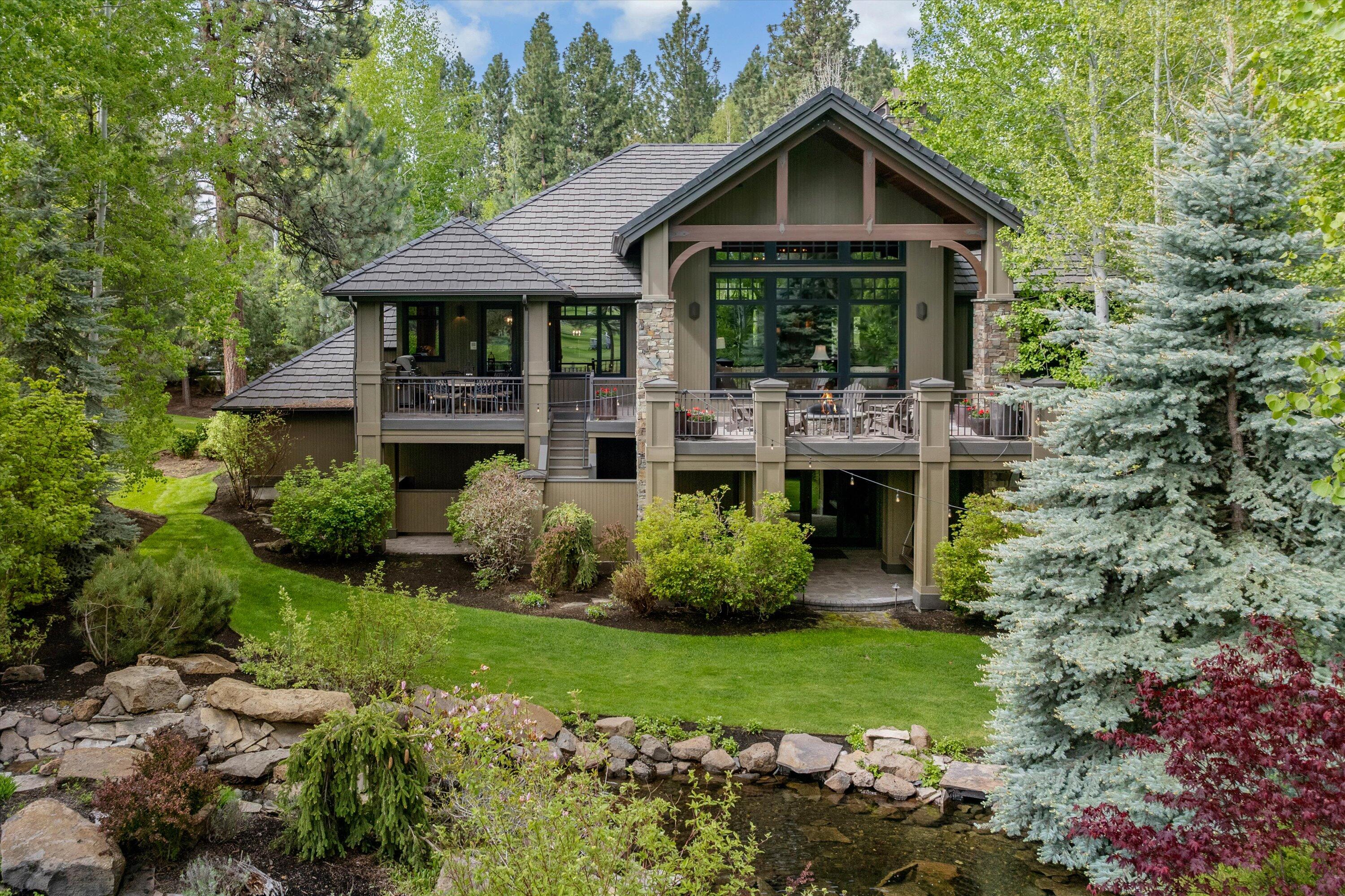 Experience the pinnacle of Bend living in this extraordinary residence within the prestigious Broken Top Community. This magnificent property is poised gracefully on the 1st green of Broken Top Golf Course. Crafted to perfection by Pacwest Builders and honored with the esteemed 2003 COBA Best in Show award, this home is a true masterpiece. As you step through the impressive entryway, adorned with dramatic dark timber exposed beams, you are greeted by an inviting great room bathed in natural light streaming through Easterly windows. The open floor plan seamlessly integrates spaciousness & sophistication, while the elegant kitchen and extended patio provide the perfect setting for memorable gatherings. Downstairs is a haven of entertainment & relaxation, including a theater room, wine cellar, cigar room and family room with a wet bar. Outside, an impressive water feature including a goldfish pond and impeccable landscaping dress the expansive half-acre lot, creating a serene oasis.
