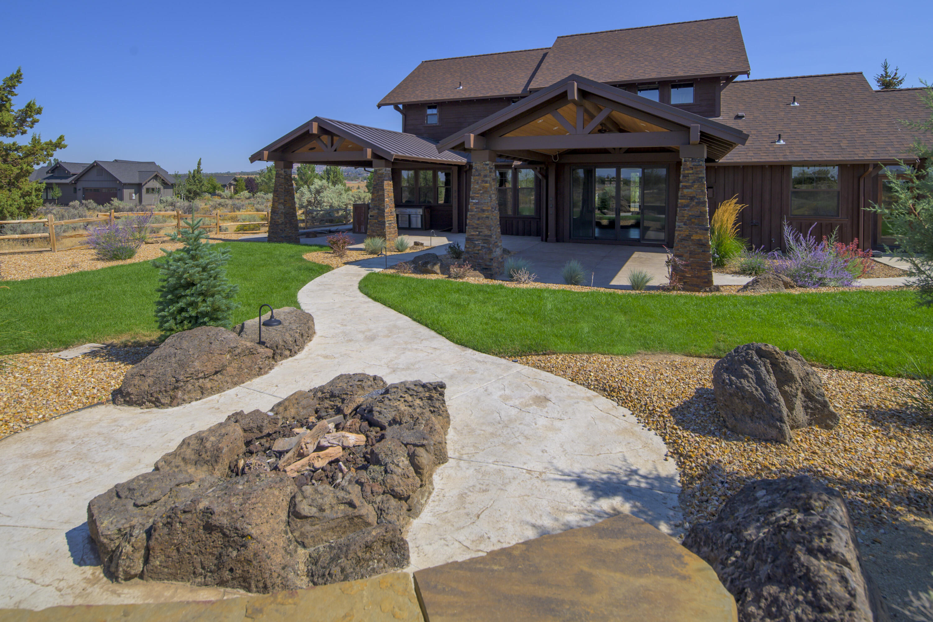 Commanding Mountain Views and a NEW kitchen greet you as you enter this warm and well appointed home in Prestigious Brasada Ranch. Inviting and open, with granite countertops, walnut  finishes, boasting hardwood floors in the great room, accented by a stacked stoned, gas fireplace, many built-in features and the Cascade Mountain View backdrop. In addition to the new kitchen appliance package, this home is excellent for entertaining. With main level living that includes two Bedrooms downstairs, The Primary Bedroom and an additional guest room or den/office, this Great room design offers spacious living and dining options, as the floor plan is as functional as it is desirable.  The upstairs family/bonus room, two guest rooms, and bathroom offers the perfect private spaces for all, with under-stair storage and a finished triple car garage. Step out back, to discover the peace and beauty of Central Oregon with TWO covered  patios, an inviting fire circle, and newly fenced yard.
