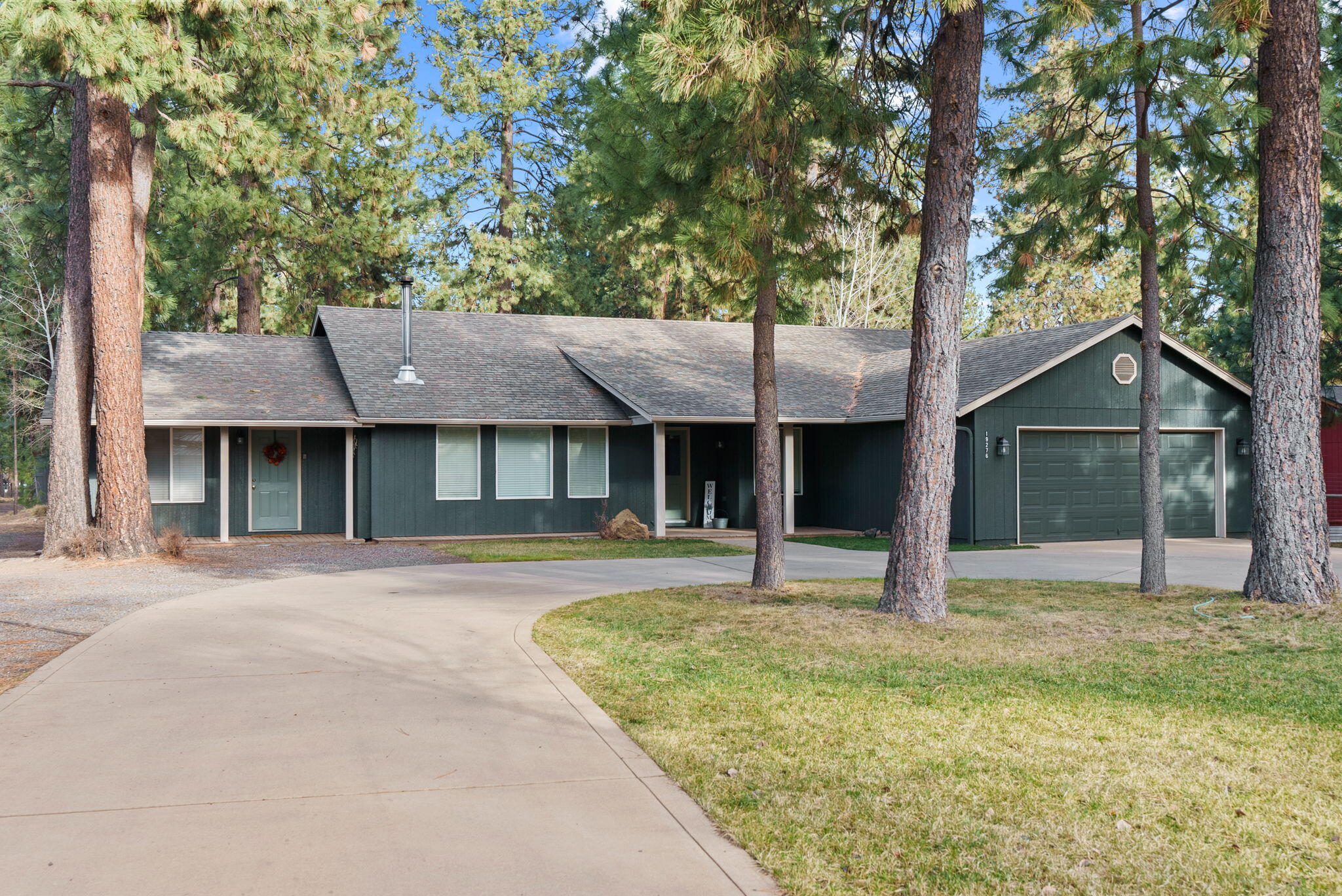Almost an ACRE in Deschutes River Woods, idyllic single-level home with space to spread out and room for projects! This beautiful 5-bedroom, 3-bath home offers comfort, versatility, and modern style. Nearly every surface has been refreshed since it was built; brand new paint, newer laminate and tile flooring, carpet, rebuilt deck, quartz kitchen countertops, painted cabinets, updated lighting,  and touches of shiplap add charm. The vaulted ceilings create an airy feel throughout the open living and dining areas. One bedroom is privately situated on the opposite side of the home with its own entrance and full bath, perfect for guests or an apartment-style suite. A large SHOP with a separate workshop provide endless potential for hobbies, or home business. Space to park your RV, relax in the yard or raise some chickens! Also, a large convenient concrete circle driveway. Enjoy the ideal blend of privacy, function, and modern updates, just minutes from town but outside of city limits!
