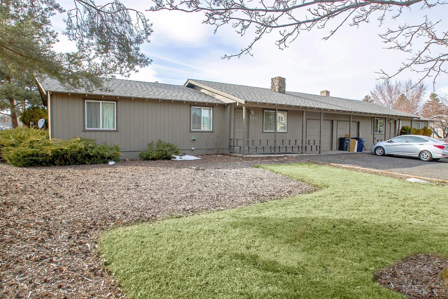 Nice duplex with 3 bedroom units and garages. Property is in good condition and nicely landscaped. Plus additional land of approximately 19,000 sf that could support additional development by hooking up to sewer which is in the street. Both sides rented- one is $1,010 with long term tenant now on month to month and the other side just entered a one year lease at $1,275.