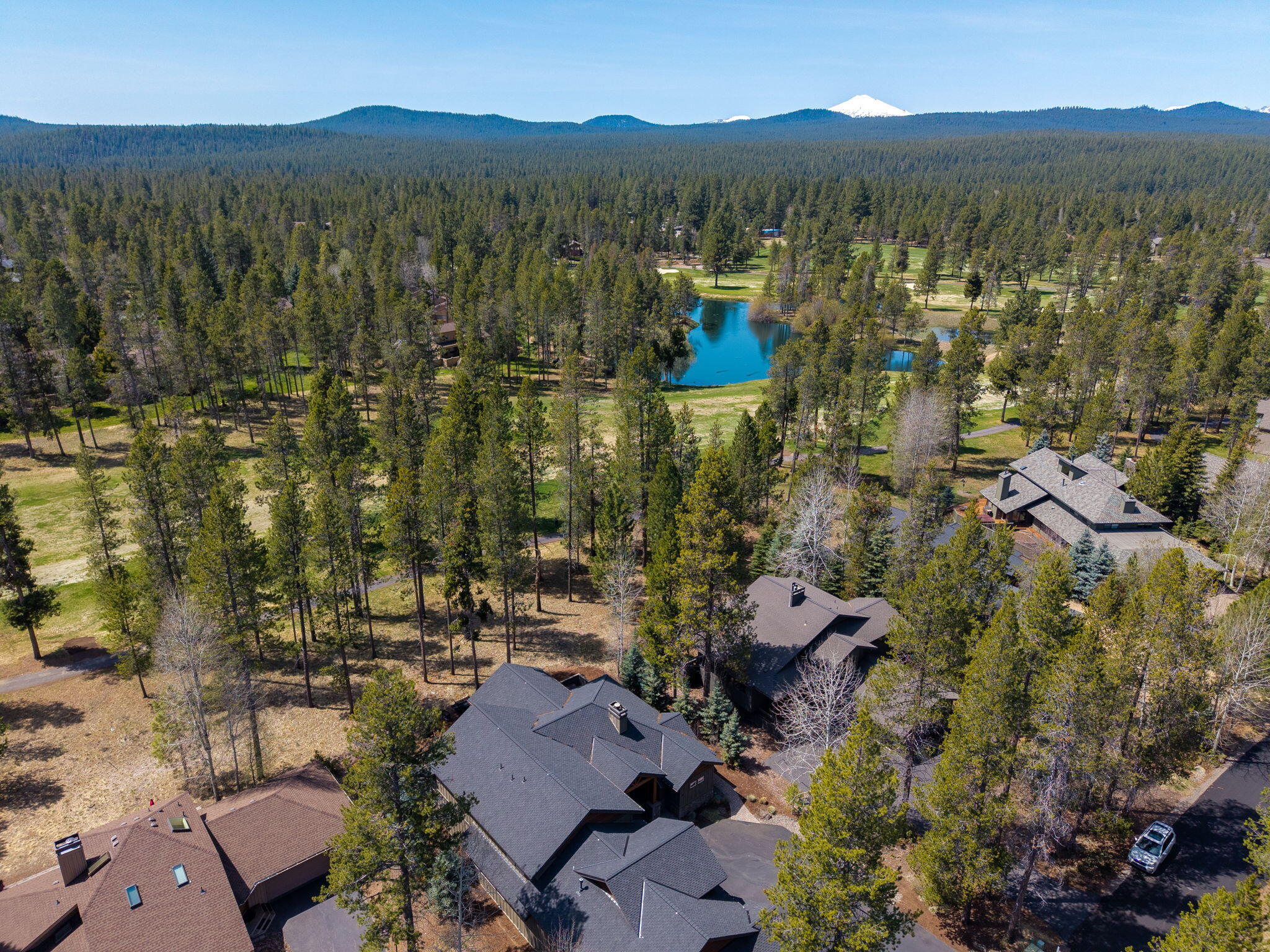 Located along the Woodlands Golf Course, #10 Fir Cone Lane is a 5-bed, 3-bath home offering  inviting living space in Sunriver! The open-concept layout showcases vaulted ceilings, a gas fireplace, & a thoughtfully updated kitchen w/ stainless steel appliances, solid-surface countertops, a prep sink, & a generous breakfast bar—perfect for entertaining. The main-level suite features a walk-in tile shower & direct access to a private hot tub. A 2nd bedroom & bath are also located on the main level, while the upper level offers 2 additional bedrooms, bath, & a versatile bonus room w/ deck, ideal for guests or recreation. Take in peaceful golf course views from the expansive back deck & unwind in the hot tub after a day of adventure. Currently an active vacation rental, sold TURN KEY FULLY FURNISHED close to Sunriver Resort's renowned amenities, including golf, tennis, biking trails, SHARC, dining, spa services & shopping, offering the ultimate Central Oregon getaway!