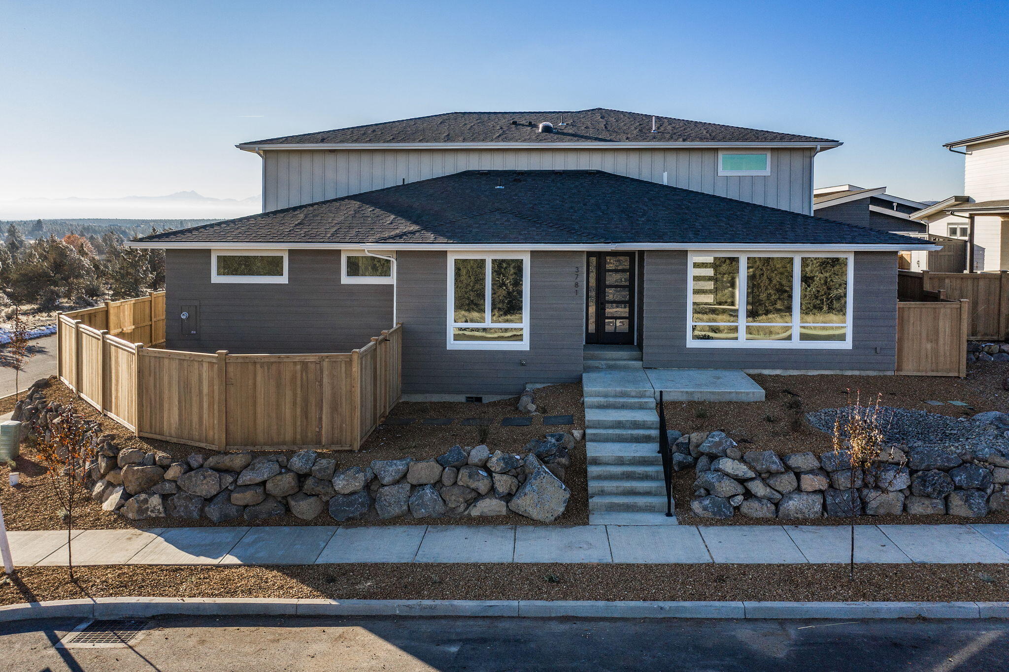 Talmage Construction at its finest. The reverse living floor plan offers 4 total bedrooms, 3 being suites with private bathrooms. Downstairs  you will find 2 bedrooms, office, 2 full bathrooms, living space/bonus area and laundry closet. The main living spaces are upstairs to take advantage of the outstanding Cascade Mountain views. Natural stone countertops and backsplash are the feature accent in the open kitchen with plenty of storage and stainless steel Bosch appliances. Beyond the kitchen and into the main living space the Cascade Mountain views shine brightly through the large windows offering tons of natural light. A large double sided fireplace separates the living room from the dining and through the sliding door to the massive second story deck. The large master bedroom and bath have private access to the deck as well. And do not forget about the nearly 1600sf garage and additional covered parking.