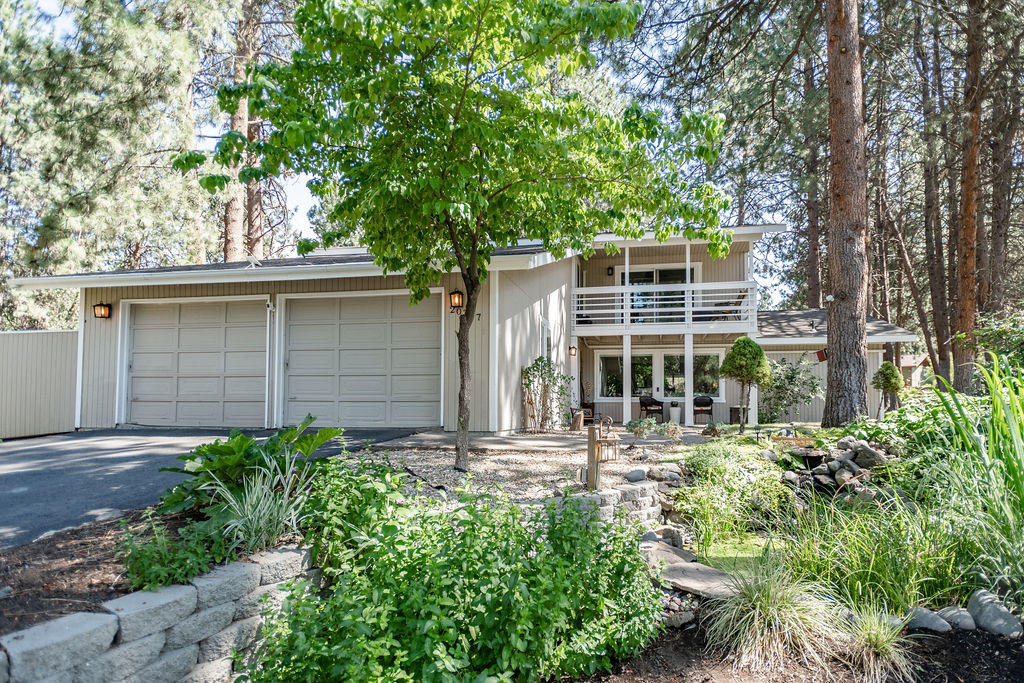 Quiet, park-like setting with established pines surrounding this beautiful home. Enjoy a tranquil backyard from the covered porch or spend evenings in peace and quiet from the upper sitting deck off of the bonus room. Primary bedroom on the main features French doors opening up to the surrounding nature. With 3 bedrooms up stairs and a bonus room, this home provides ample space. This home is located in the Timber Ridge neighborhood, adjacent to Bend Golf & Country Club in SE Bend. HOA covers yard care and watering.