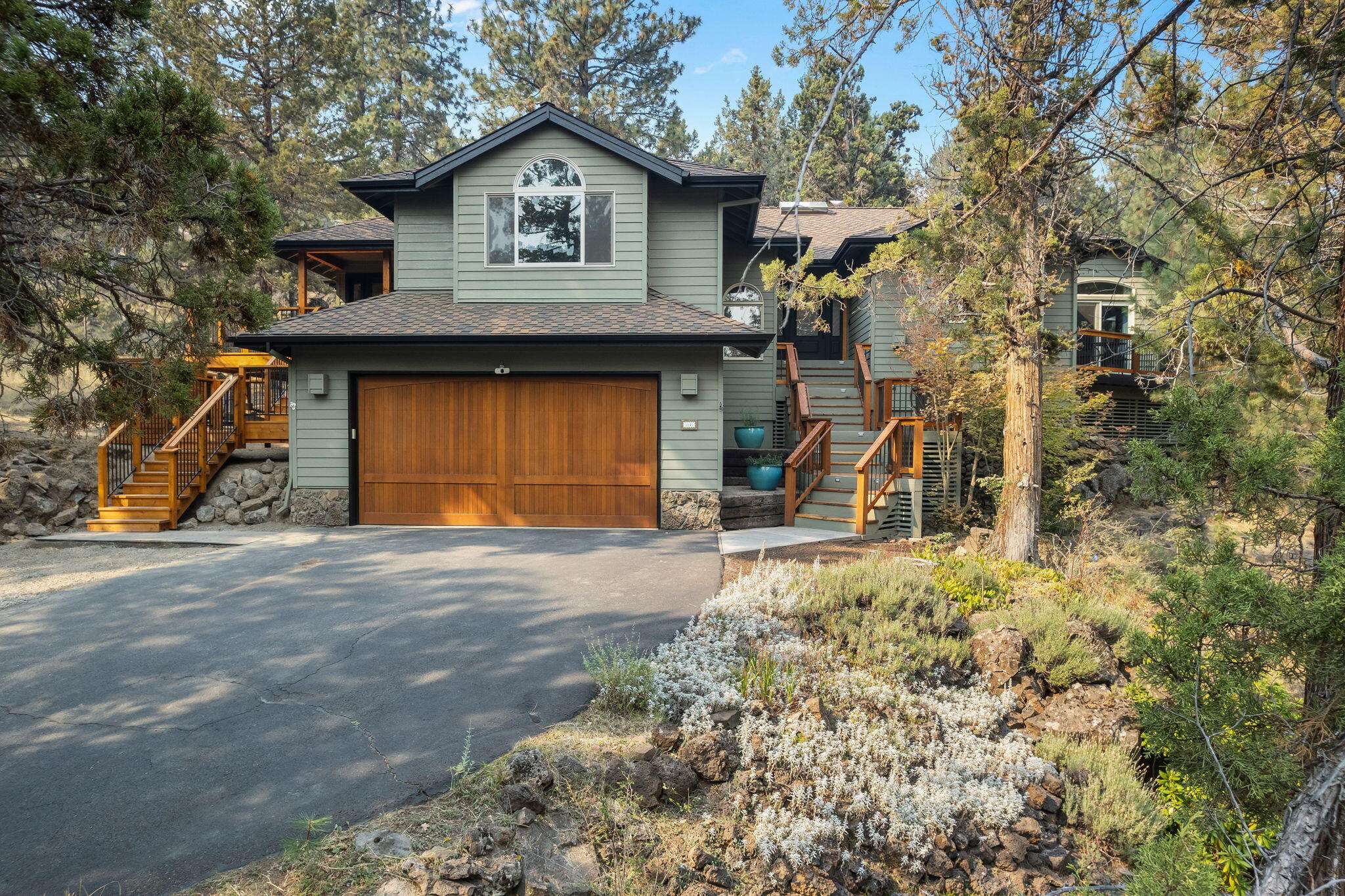Enjoy private access to the Deschutes River and scenic trails in the Rimrock West neighborhood w/ this stunning home on over half an acre. This single-level gem features an open floor plan w/ large windows, high ceilings, spacious living room w/ wood stove insert and the well-appointed kitchen is equipped w/ high-end stainless appliances and leathered granite countertops. Step outside to enjoy the generous deck complete w/ newer hot tub perfect for relaxation and entertaining. The primary suite serves as a private retreat, featuring a tiled bathroom and a large walk-in closet. The ensuite includes a full bath & laundry leading to a 350 sqft bonus room w/ a gas fireplace. This versatile space has its own private entrance and French doors that open to a charming wrap-around deck—ideal for generational living, ADU or home office. Includes additional detached 2-car garage for ample storage for all your needs. Embrace the tranquility of this property while located close to all things Bend.