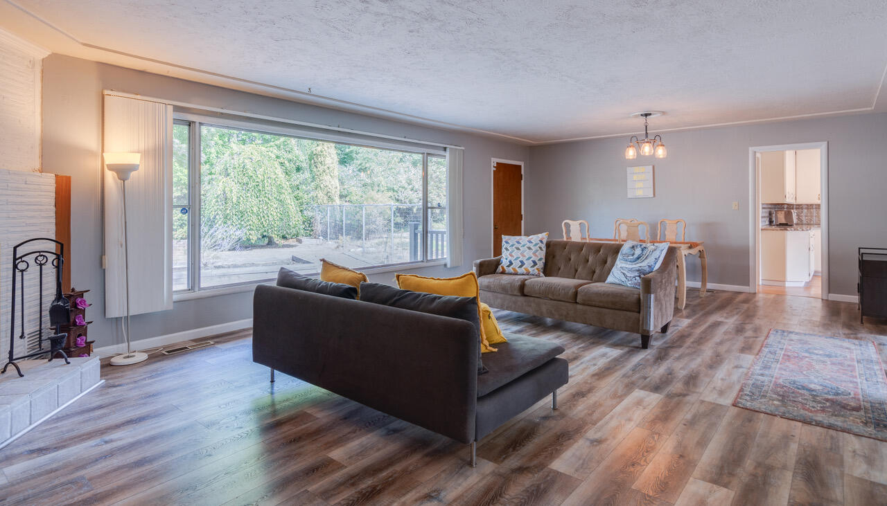 Experience the charm of this mid-century home in the heart of East Medford, blending classic style with modern updates. The bright living room features a brick fireplace and large picture window, filling the space with natural light. Original wood built-ins add warmth and character throughout. Updated kitchen and dining area are perfect for entertaining, while a versatile third room works as an office or bedroom. Enjoy the spacious and private backyard with raised garden beds, rose bushes, and a big Trex deck for outdoor relaxation. Additional features include garage, carport, newer flooring, professional kitchen appliances, granite counters, and $30k in recent insulation upgrades. 10'x14' workshop in the backyard offers a blank slate as an art/music studio, man cave/she shed? Conveniently located near schools, shopping, medical offices, and the Rogue Valley Country Club. A recent whole-house inspection (clean report) is available.