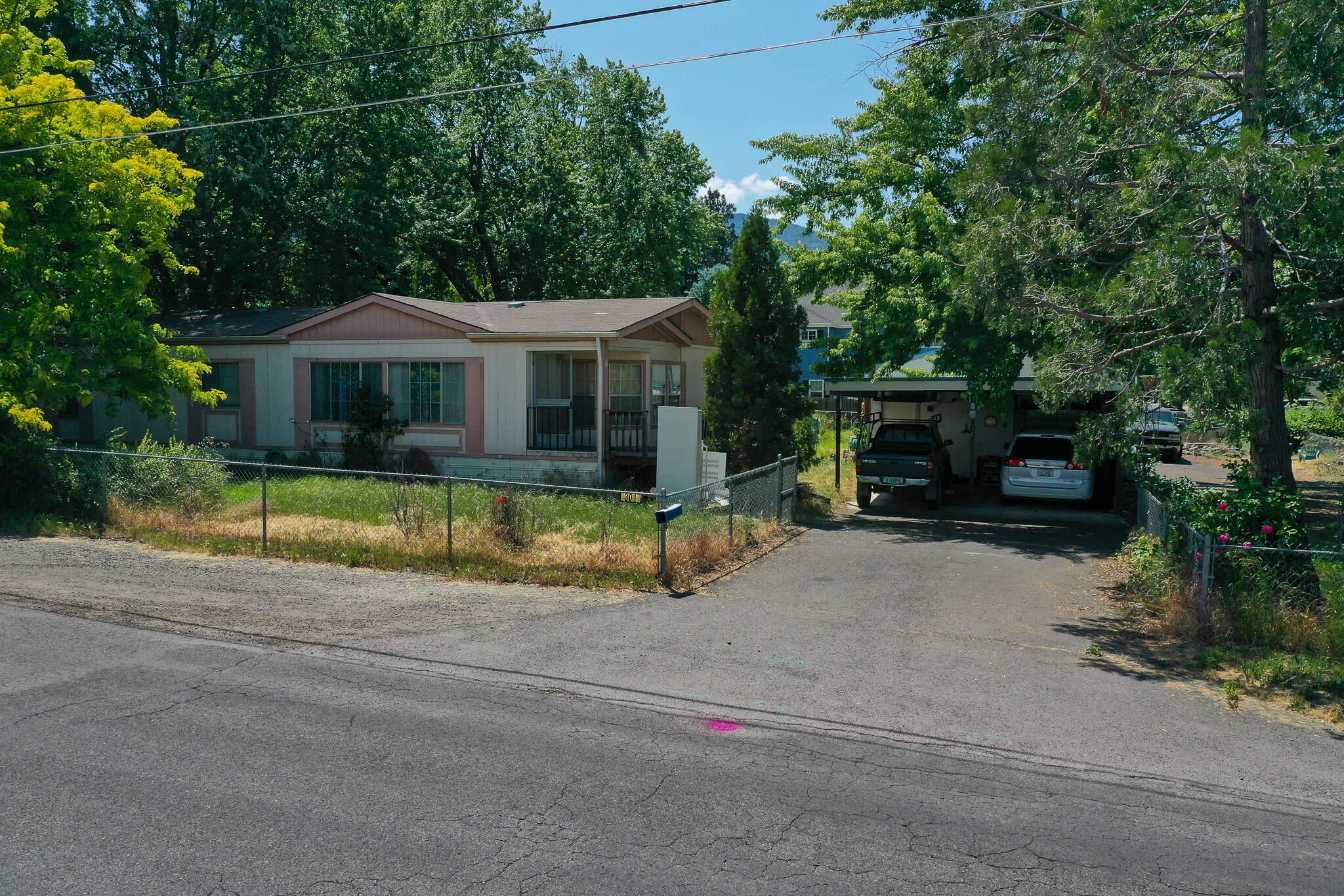 Come tour this property with mountain views, minutes away from many of Ashlands amenities and close to downtown. It is a 2/2 manufactured home with an office that sits on an its own generous size lot. It also has a detached garage with plenty of space for multiple cars and have a workshop area or turn it into whatever you desire. There is also a storage area attached to it.