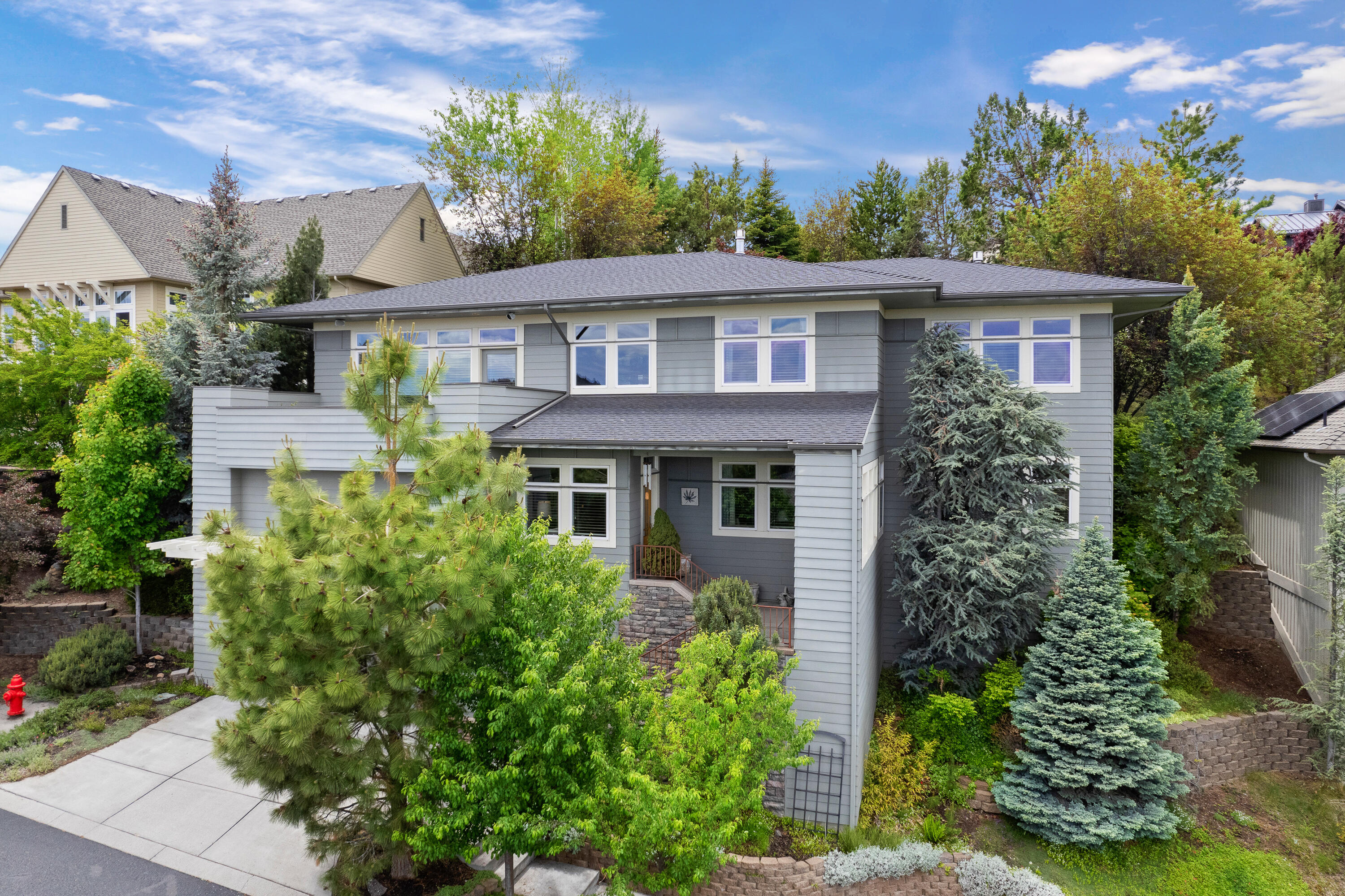 In Bend River Heights subdivision, this unique home is designed to capture the best of living in Bend.  Located in the heart of town, it's within walking distance to downtown and Deschutes River trails. The views are breathtaking, reaching from South County all the way to Smith Rock to the north and as far as the eastern mountains to the east, with river and city views in the foreground. The beautiful 4 bedroom/3 bathroom home is light and bright with high ceilings, oversized windows and open living spaces. The bedrooms include two primary suites featuring fireplaces, walk-in closets and large bathrooms. Special features of the home include a newly remodeled kitchen, wide solid oak floors and new carpeting. The front and back paver patios are ideal for entertaining, emphasizing the landscaped back yard to the west and expansive views to the east.  Step out of the ordinary and check out this one-owner home that provides all the best Central Oregon has to offer.