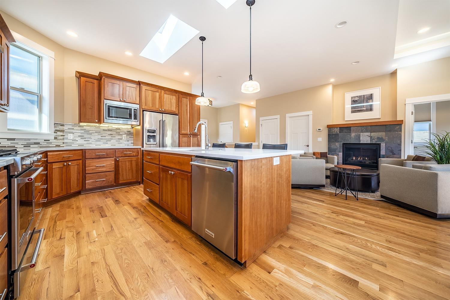 New $10,000 Buyer incentive!! $10,000 credit w/full price offer for this immaculate home. Credit can be used at buyer's discretion to add additional outdoor space, new furniture or a price reduction. Beautifully built in 2016 by Magnolia Fine Homes. Great location w/mountain views, near downtown & 40 acre park. Sleek & contemporary open floor plan. Gleaming hardwood flooring in main living areas, natural light throughout, walls of windows & gas f/p with slate surround. Gourmet chef's kitchen w/quartz & marble slab counters, Kitchen Aid SS appliances, gas cooktop, dining bar, skylights & outdoor deck. Main level suite w/vaulted ceilings, walk-in closet & luxurious bath w/quartz counters, heated tile flooring & marble shower w/tile inlay. Lower level w/spacious 4th bedroom that would make wonderful media room, office or studio/den w/private entrance. 2 additional bedrooms full suites w/upscale bathrooms & walk-in closets and laundry. Finely finished, beautiful cabinets throughout.