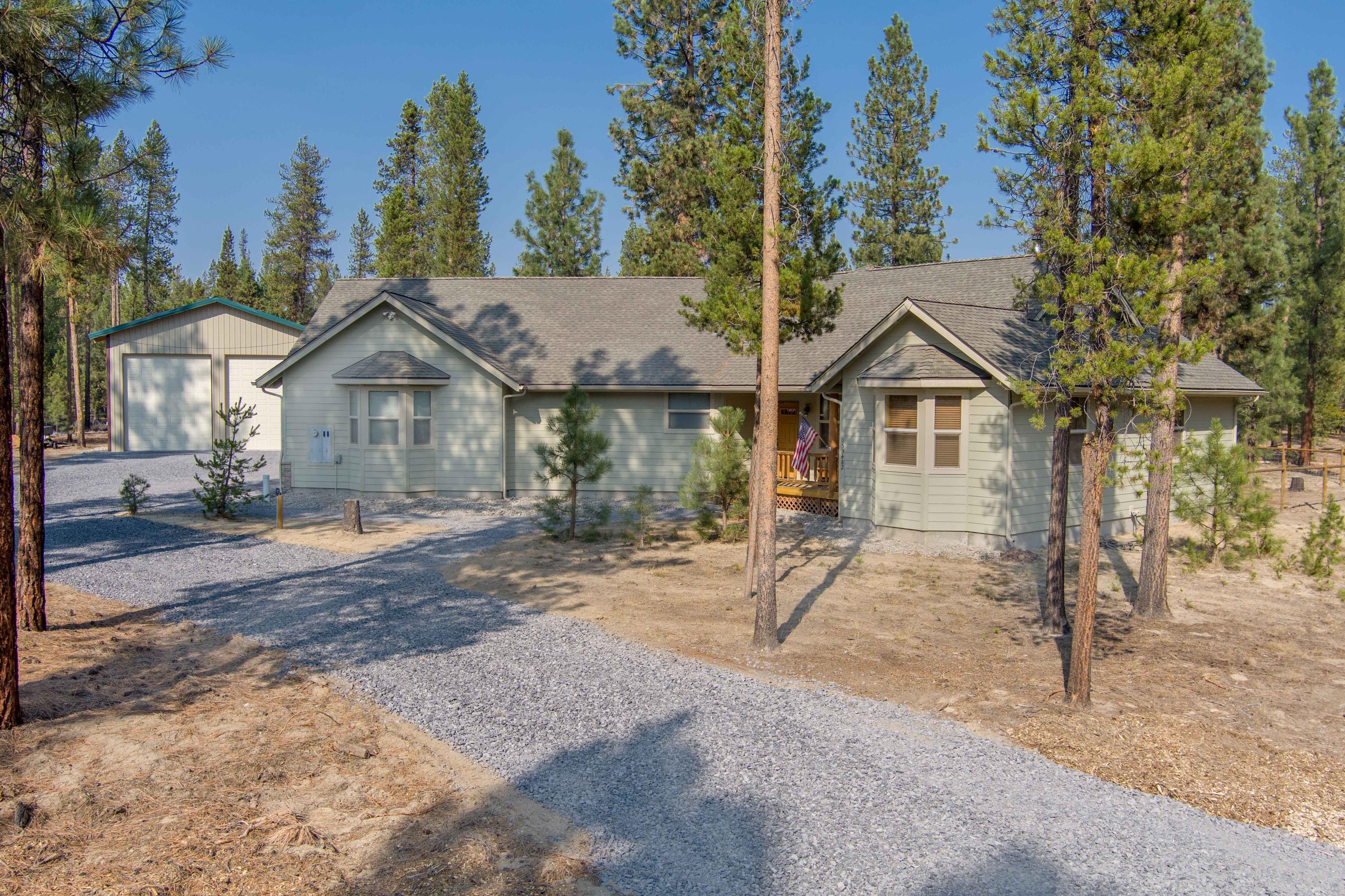 Enjoy Central Oregon living amongst the Ponderosa Pines. A modern stick-built home situated on 1.34 acres features an open spacious kitchen, lifetime guaranteed 8'' plank hardwood appearance, flooring. Living room has wood burning stove to stay extra cozy in the winter. Master bedroom offers a private bath and walk-in closet. Two additional bedrooms and 2nd bath. Separate laundry room with large sink. Lovely covered porches, front and rear are perfect location to BBQ or relax and watch the wildlife. The attached garage is finished and door is insulated. Newly constructed 30' x 36' shop, 14' high doors, insulated roof, concrete floor, roughed in plumbing, 100 amp power with outside 50 amp RV plug. Additional RV parking area with 30 amp power, plus water and sewer hookup. 12' x 15.5' wood shed with concrete floor. Wagon Trail Ranch offers clubhouse, seasonal heated swimming pool, trails, and recently awarded Firewise Certification.