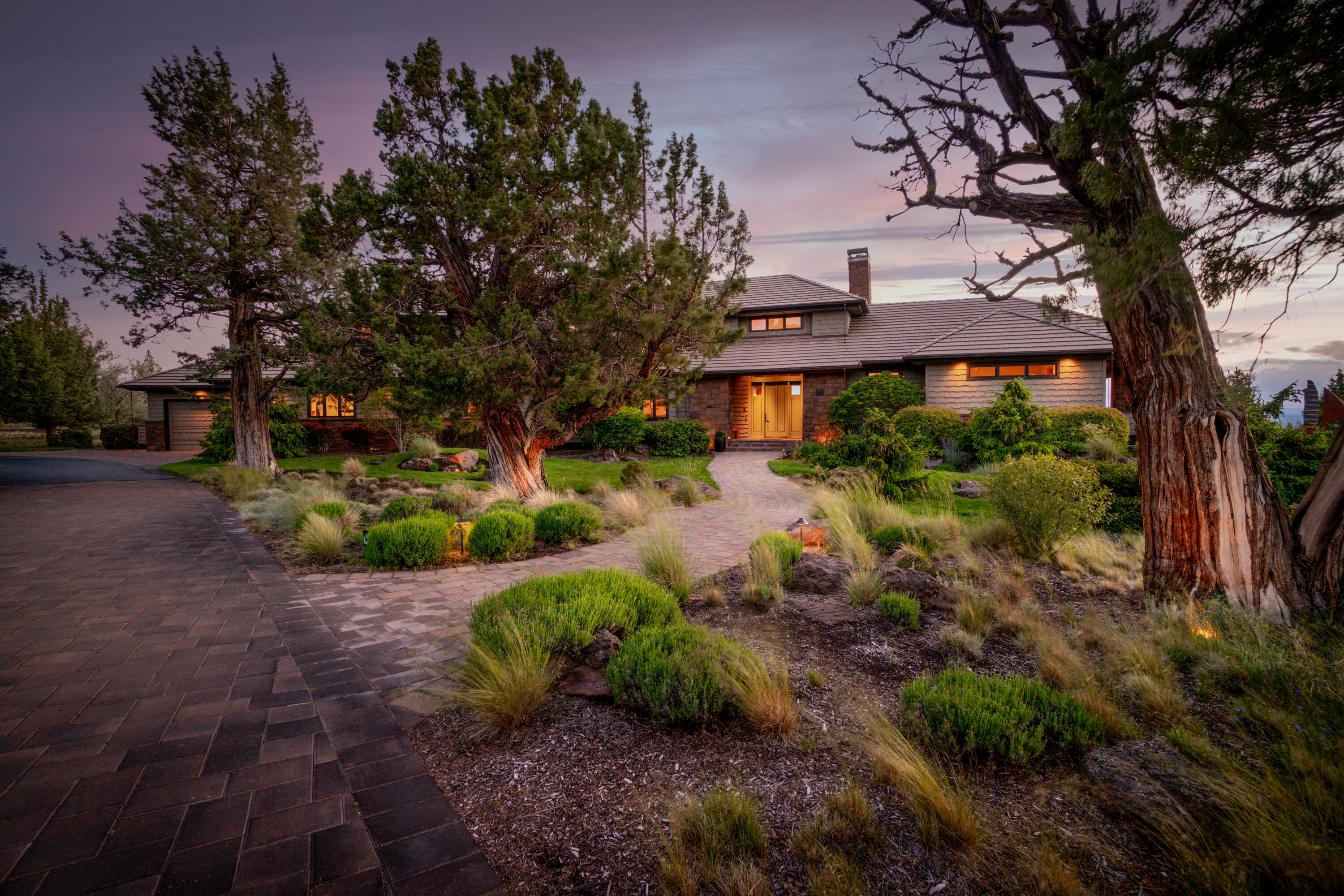 A timeless home with a priceless view on a premier estate lot in Tumalo's Grandridge estates, this Norman design is one to remember. Here, a stately entry and wrap-around driveway open to an exceptional main-floor living layout with the finest craftsmanship and materials including Canadian maple floors, black walnut cabinets, expansive Jeld-Wen windows, and so much more. The private primary bedroom features incredible mountain views from every angle, a large bath with Japanese soaking tub and walk-in closet, and a secluded patio with hot tub from which to take in the morning glow of the mountains or the countless stars in a clear night sky. Three additional suites ensure comfort and space for all. Outside, grill or lounge beside a 'babbling brook' water feature that weaves along the back patio. In addition to the three-car garage for the main home, enjoy a private separate shop designed for easy conversion to an artist studio or guest space. Home utilities have recently been updated.