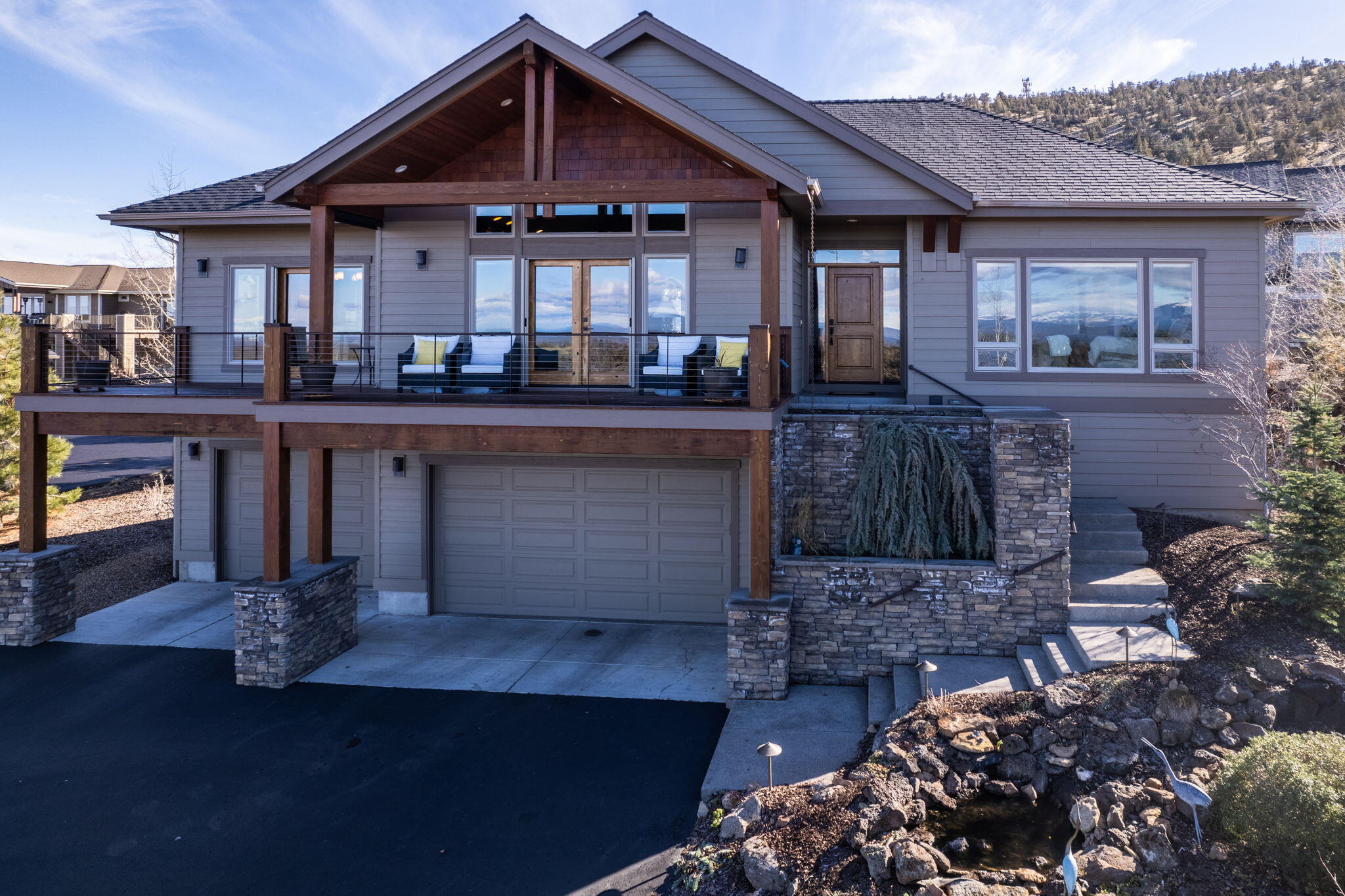 This FURNISHED custom home offers stunning views of the Cascade and Ochoco Mountains, Black Butte, and Smith Rock. Step inside and be captivated by the open floor plan, vaulted ceilings, stacked stone fireplace, solid hickory floors, and knotty alder cabinetry throughout.

The spacious kitchen is a chef's dream, featuring endless slab granite countertops, custom cabinetry with specialty storage drawers, and high-end appliances.

Enjoy your morning coffee on the front deck, taking in the breathtaking views, or relax on the private deck in the back, complete with a fan and a heater for year-round enjoyment.

The primary suite is a sanctuary, with a walk-in steam shower, and dual-sink vanity with solid quartz countertops.

With a full bath and two guest rooms, including one with a built-in Murphy bed and workstation, there's plenty of room for guests.
Extended triple-car garage with room for a workshop. Plus, the large driveway and parking pad make hosting guests a breeze.