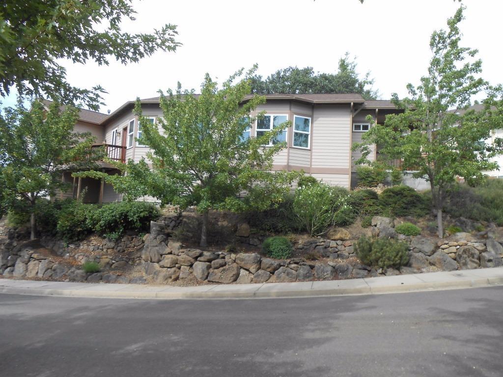 Gorgeous single family home sitting high on a hill with spectacular mountain views!!! Home is located in the sought after Great Oaks neighborhood of Mountain Meadows 55+ Community. Expansive views from the numerous windows and front deck of this spacious home. Walk into the tiled entry way and you will find a lovely office/den to your right. Straight ahead is the gorgeous Living/Dining area with beautiful hardwood floors, vaulted ceilings, a wall of windows, and a gas fireplace surrounded in shelves. Glass doors off the dining area lead to a large rear deck, great for entertaining. Beautiful, well appointed kitchen with breakfast area where you can walk out on the deck and enjoy the views & your morning coffee! Large Master Suite with walk-in closet, nice bath, and more windows to enjoy the views! Home has central vacuum system, 2 car garage, and a very small partial basement that would be great for extra storage. This is a one of kind home with a great location!!
