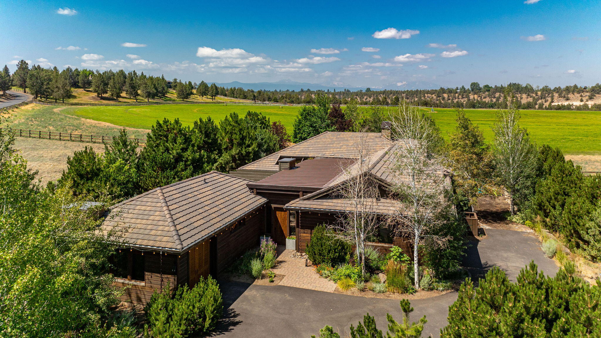 An inspiring and private setting located in sought-after Deschutes River Ranch: Bend's historic working ranch in the heart of Tumalo. Situated on a .42/ACRE lot, this timeless Northwest design offers a SINGLE LEVEL floorplan w/breathtaking Cascade Mountain and pastoral views. Stunning Great Rm features an exquisite fireplace w/stone and copper accents & a wall of windows framing the mountain vista. Chef's Kitchen w/exposed beams, expansive working isl and stainless appl opens to the spacious Dining Area. Primary Suite boasts more phenomenal views, dual vanity, soaking tub & tile shower. Generous 2nd Bedroom + full BA. Separate Casita w/private entrance is a fantastic Guest Rm or secluded Home Office. Multiple outdoor spaces to enjoy: Dine al fresco by the dramatic firepit in the CHARMING front courtyard or take in the Cascade views from the back covered patio. 10 minutes to Downtown Bend. Private river access, fly fishing, trails, swimming hole & access to 32,000 acres of public land.