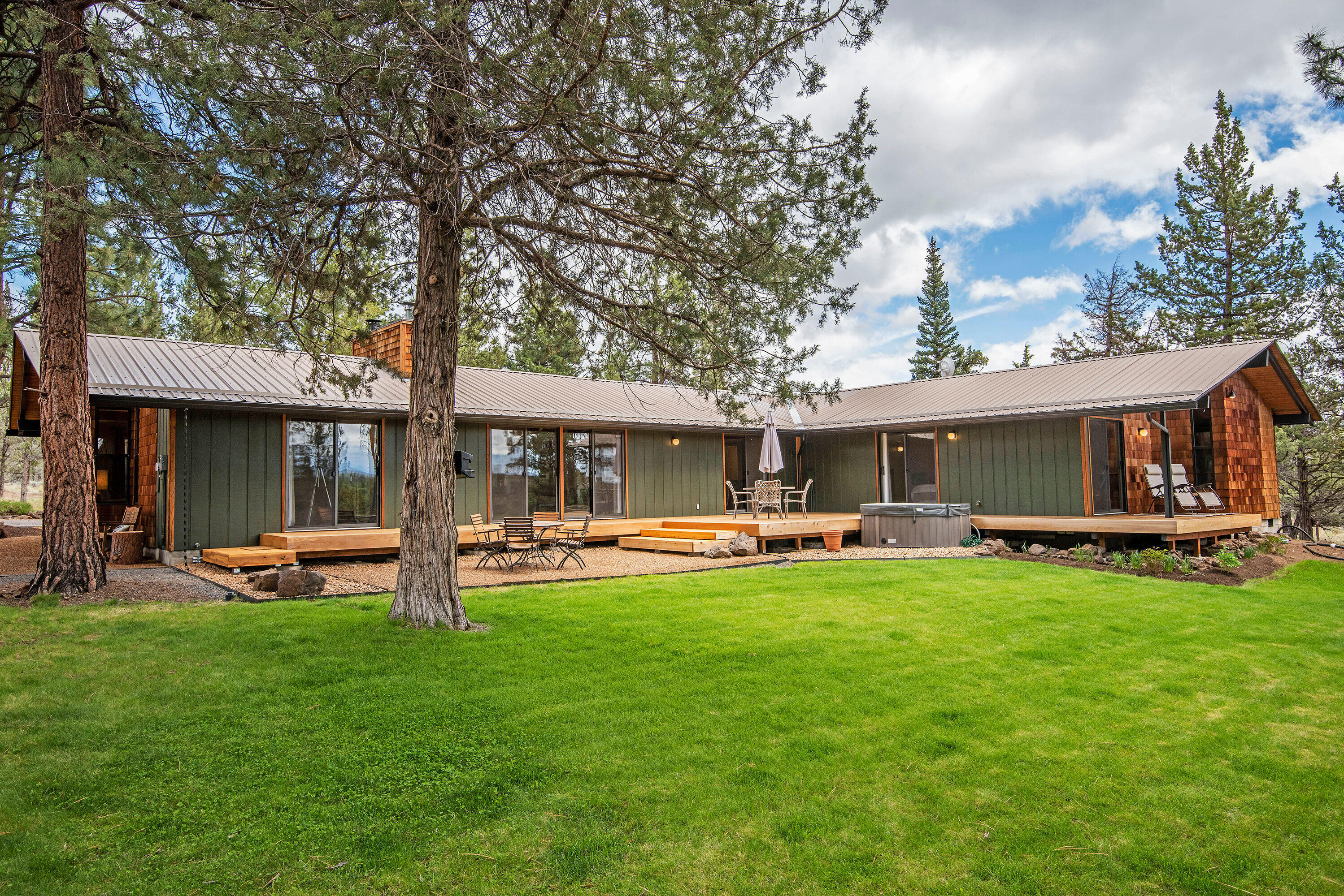 Privacy and tranquility abound on nearly 10 acres just 3 miles from downtown Sisters. One of a kind completely renovated single-level 5 bedroom home has a modern yet natural feel with stone and wood throughout. Floor plan features 3 separate bedroom wings, each with a full bath and vaulted ceilings. 7 sliding doors lead outside and to the new cedar deck. Over 70 linear feet of closets. All appliances, kitchen and bathroom cabinetry and major house systems are new within the past 3 years. High-efficiency inverter heat pump with multiple zones just installed in 2021. 2 EV charger connections. Owned 5kWh photovoltaic solar system and southern exposure passive solar design. Nicely elevated lot with views of Tam McArthur Rim, Broken Top and Paulina Peak; the Three Sisters can be viewed from the SE corner of the property. Property backs to a 193 acre parcel. Seller is a licensed Oregon broker.