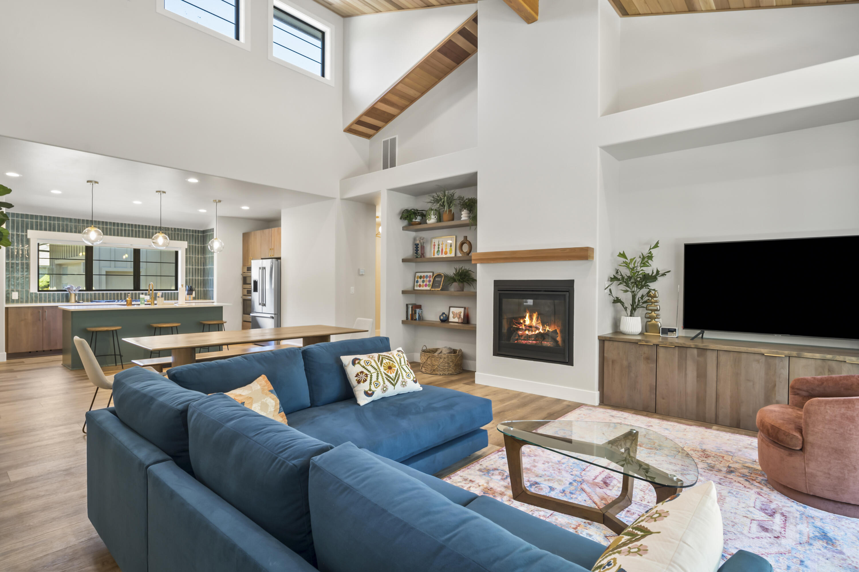Enjoy refined living in this beautifully designed home set within one of Sunriver's premier golf course communities. Soaring ceilings and expansive windows define the open-concept great room, creating a bright space for entertaining or relaxing. The gourmet kitchen features quartz countertops, designer tile, and premium stainless appliances. The luxurious primary suite includes a spa-like bath with soaking tub and walk-in shower. Two additional bedrooms offer flexibility for guests or a home office. Step outside to a covered patio and private yard. The spacious 856 sq ft garage includes an attached gym/studio—ideal for workouts, hobbies, or creative projects. Just minutes from Sunriver's trails, SHARC, and Village amenities, this home blends modern comfort with resort-style living—perfect as a full-time residence, vacation getaway, or investment. Furniture and bikes are included in the sale. Excluded items are the artwork and paddle boards.