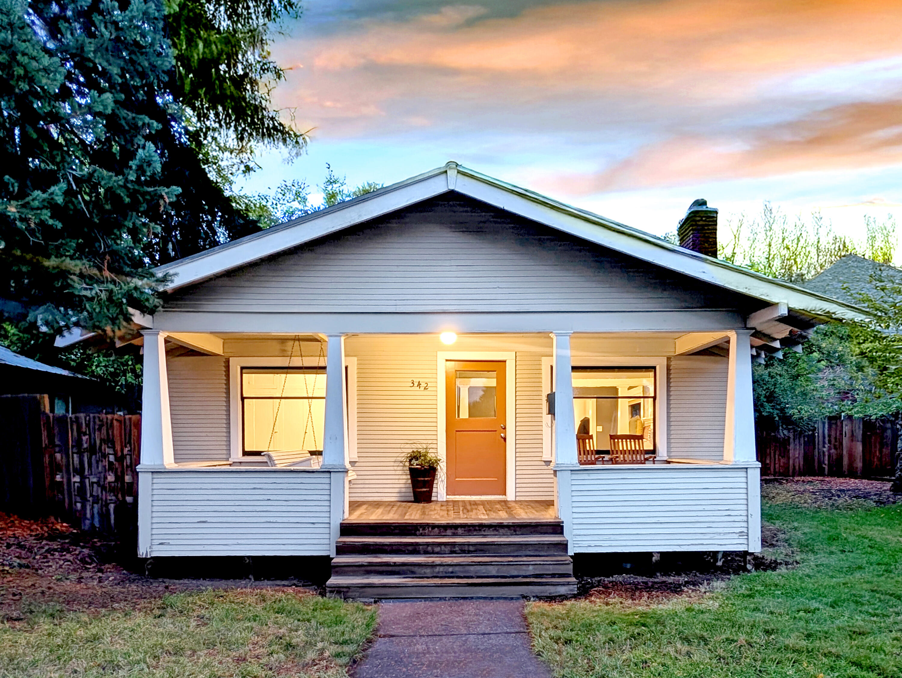 Welcome to this delightful 1925 bungalow, a blend of historic charm and contemporary living. 1,108 square feet offers two bedrooms and one bathroom providing a welcoming retreat for anyone seeking character and comfort. The living room features a striking fireplace that adds warmth and style while the larger bedroom offers a walk-in closet with abundant storage. Throughout, there are original touches that capture the essence of this home's era. Start your day on the covered porch swing and then enjoy the spacious backyard for evening gardening or gathering with friends. Alley access to parking and a detached shop offers convenience and development opportunity. Nestled in the heart of Bend's Historic district, this bungalow provides easy access to downtown, shopping, dining and the Deschutes River, while also offering a peaceful neighborhood vibe. Add your personal touches and make this charming home your own.