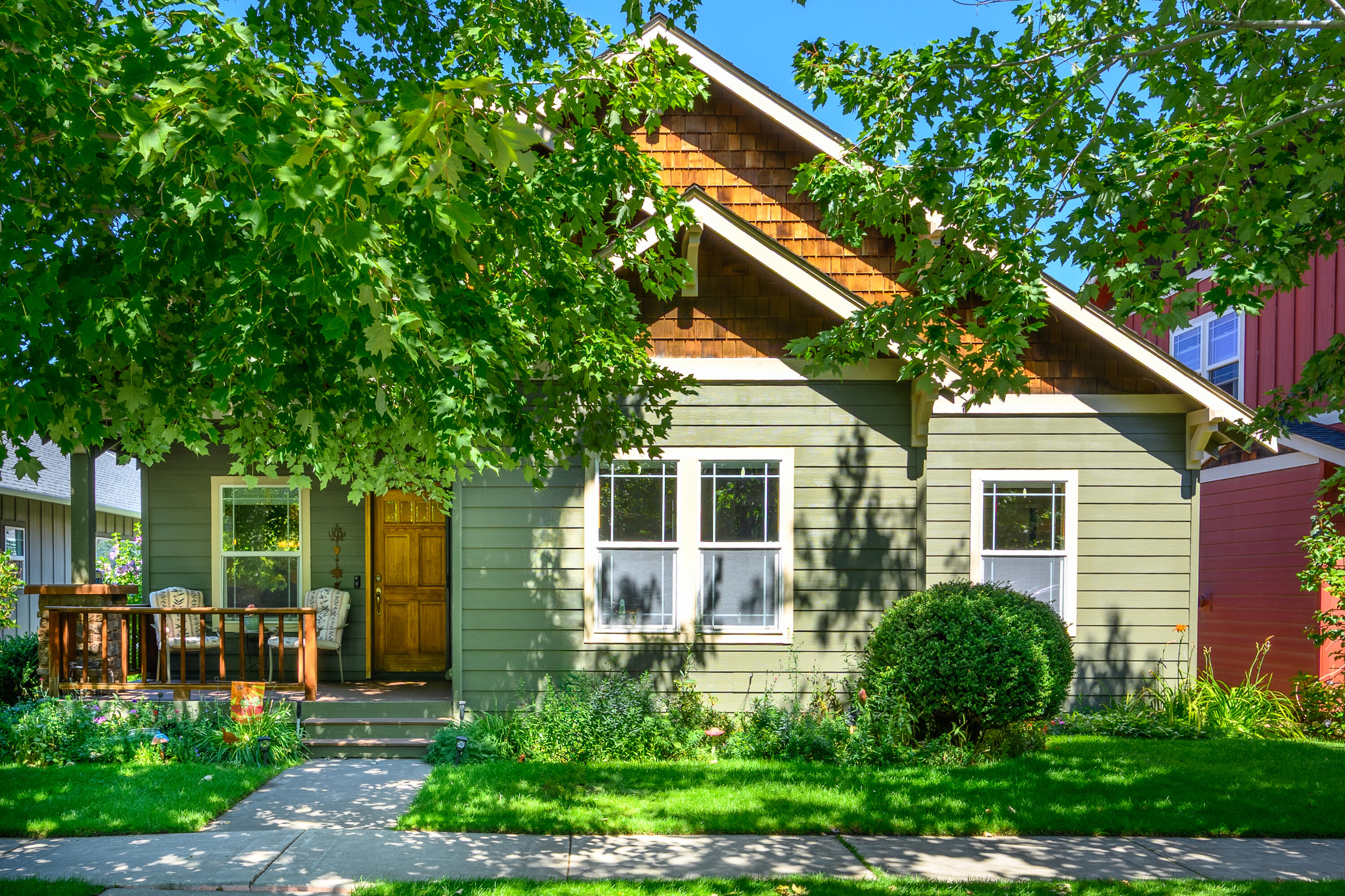 This single level craftsman home is adorable! Extremely well maintained and cared for it has a new trex deck front and back, a new heat pump and fresh exterior paint last year. A gas fireplace in the living room keeps you cozy and 3 well-proportioned bedrooms are lovely. The dark green granite counters and hard wood floors  in the kitchen are timeless. This home is low maintenance with easy garage access from the alley with only 3 steps into the house. A fenced and sunny back yard has a lush lawn and flowers and shrubs along the perimeter. No houses directly behind this home creates a feeling of space and adds privacy.  Situated in NE Bend in the popular Oakview neighborhood it sits on a quiet tree-lined street close to restaurants, medical, parks and shopping.