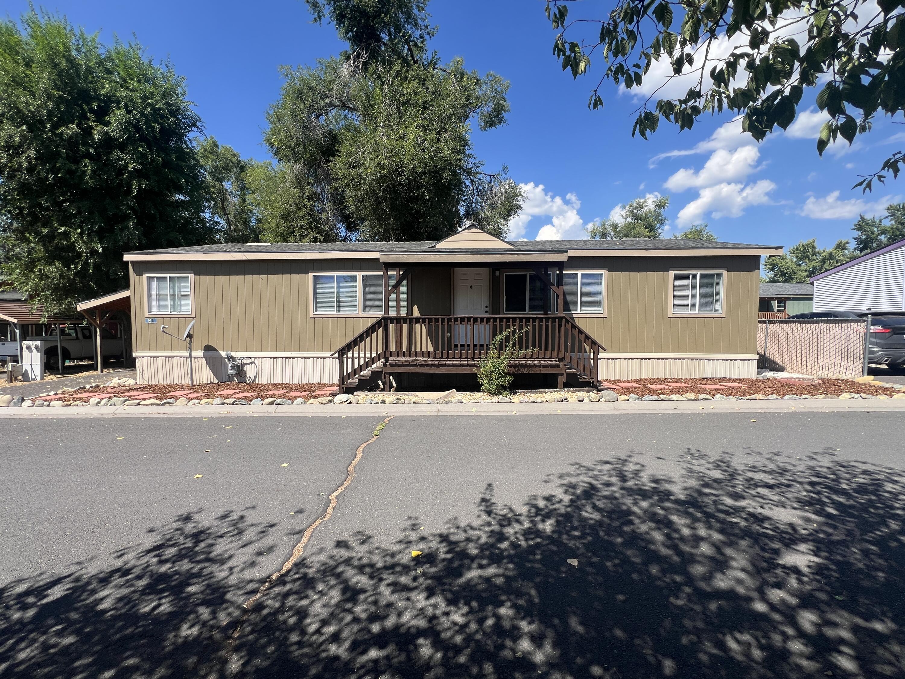 With full price offer, upon closing seller will put new laminate on kitchen countertops OR will replace one of the bathroom tubs and fiberglass surround. New carpet in bedrooms, new laminate flooring in living space, and bathrooms, roof/vent repairs and duct cleaning. A Must See! This manufactured home is in a nice family park, close to highways 97 and 140, downtown, transportation, and a small market. With over 1400 sq ft, this split floorplan provides adequate living space with both a living room and a family room, a decent sized dining area, and a spacious kitchen with an island. The primary bedroom has a large en suite and a walk-in closet. The front porch is newly painted, and the front landscaping has been recently completed. The exterior paint is newer, as is the water heater. The roof is less than 10 years old and has been inspected; furnace has also been inspected. The seller has recently replaced bathroom sinks and faucets as well as some of the lighting.
