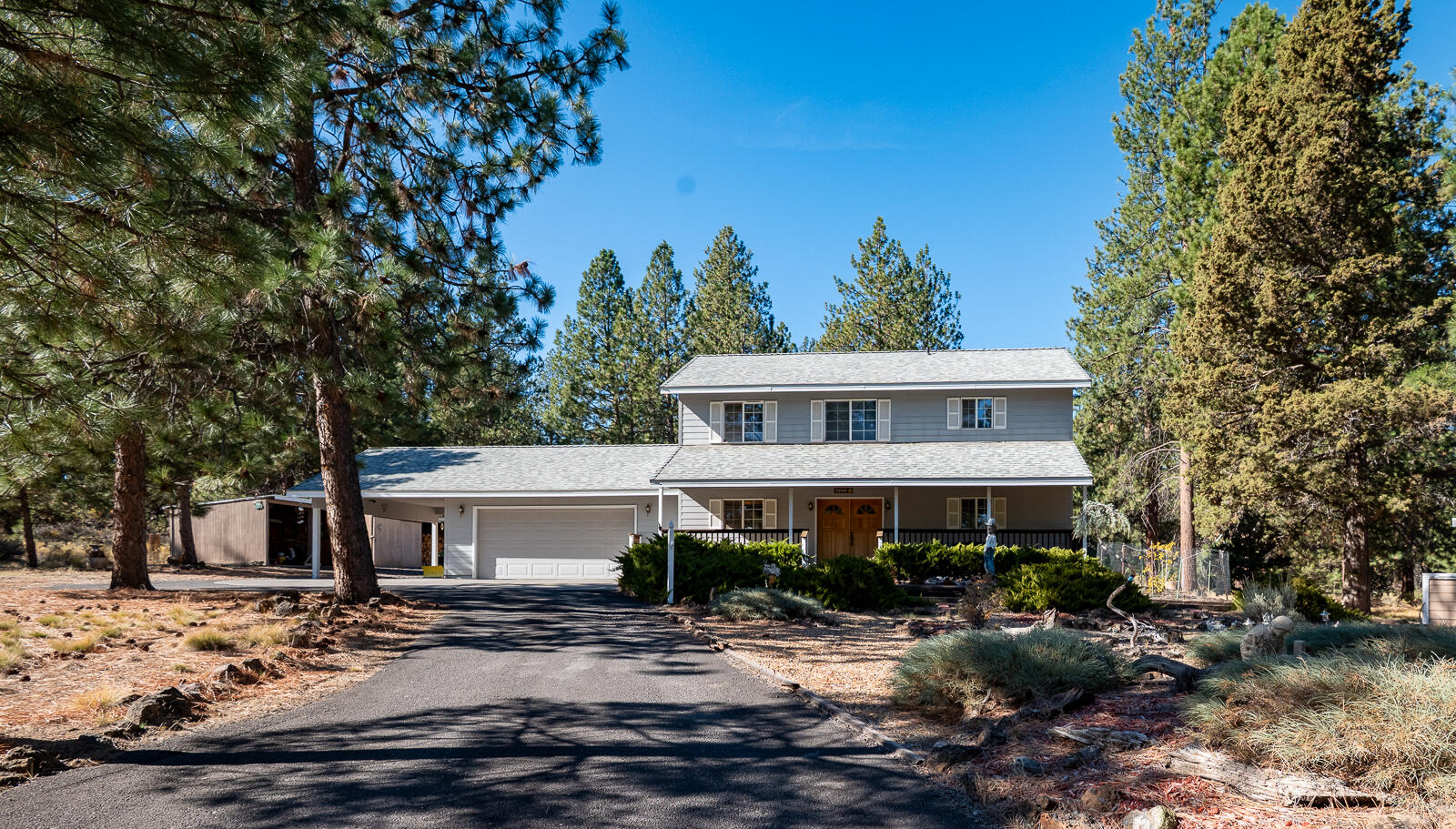 Nestled on 5 serene acres in Buck Canyon among towering ponderosa pines, this home offers privacy, space, and incredible potential. Featuring a main-level primary suite, open floor plan with vaulted ceilings and large windows, and cozy wood-burning stove, it's ready for your vision and updates. The upstairs provides additional bedrooms, including one with a balcony overlooking the yard. Exterior highlights include a 2-car garage, carport, covered porch, decks, outbuildings, and natural landscaping. While the property is in need of some tender loving care, it presents a wonderful opportunity to make it your own and create a special retreat in a sought-after Bend location.