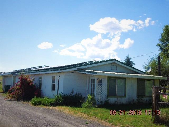 12883 Hwy 66: Looking for country living close to town? This 3 bedroom, 1 bathroom home on 2.61 acres could be just the property for you. Featuring some updates throughout, vinyl windows, tile, laminate, and carpet floors, 50 year metal roof, and 2 in 1 heat pump with AC. Kitchen is open to the dining and living room with large pantry/ storage room. Nice heated 2 car garage with laundry area and work bench. Through the garage is a fully fenced back yard with shed and pump house. Small animal shelter with pasture for your farm friends and flood irrigation available. Not to mention, the solar system on roof provides 100% of homes annual electricity usage. Call today, to make your showing appointment!