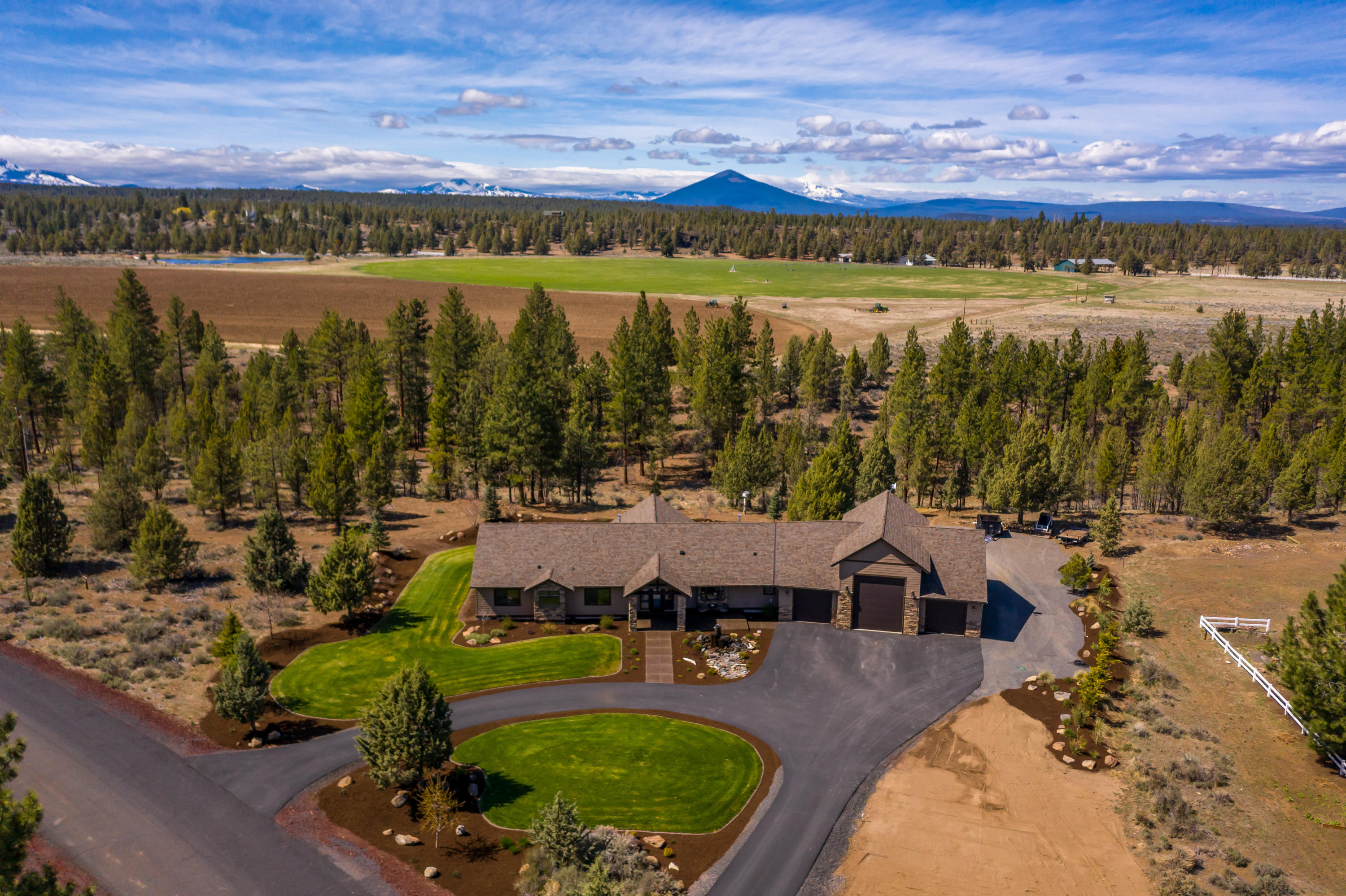 Immerse yourself in luxury! You'll be wowed by this one level floor plan, designed by the homeowner it has something for everybody. Home rests on 1.19 acres of meticulously cared for grounds. This home boasts the finest of finishes and materials throughout. Relax and enjoy the open living space flooded with natural light and beauty. Expansive wall of windows overlooks the private backyard w/covered patio and hot tub, a perfect spot for entertaining the family and friends. Gourmet kitchen, w/ Hemlock custom cabinets, slab granite counters, under counter Blanco sink, island, KitchenAid appliances, gas cooktop, built-in oven/microwave and warming drawer. Elegant Master suite and private en suite bathroom that will not disappoint. Conveniently located between Bend & Sisters, Bend address in Sisters School Dist. Your dream home awaits, complete w/attached 38' deep RV Bay.  Bend Broadband High Speed Internet up to 1 Gig is available. Access to the National Forest from this neighborhood.