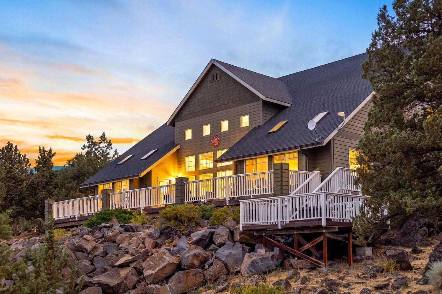 Expansive Estate Home on 5 beautifully unique acres with incredible rock outcroppings & sweeping views of the Valley, Ochoco Mountains, & City Lights. This stunning home offers space, elegance & flexibility; just a short drive to Prineville or Redmond. Inside, you're greeted by grand two-story ceilings & floor-to-ceiling windows that flood the living space w/natural light. The spacious main-level primary suite provides a peaceful retreat with scenic views. A large office on the main floor could easily serve as a 5th bedroom or hobby room; ideal for multi-generational living. Upstairs, you'll find three additional bedrooms, along with a loft area. Step outside to the expansive multi-level deck: ideal for relaxing, entertaining, or soaking in the Central Oregon sunsets. The deck is hot tub-ready w/hookups. Room to build a shop & a private yet accessible location, this property is a rare find. Looking for a peaceful getaway or a home close to town w/room to grow, this has it all.