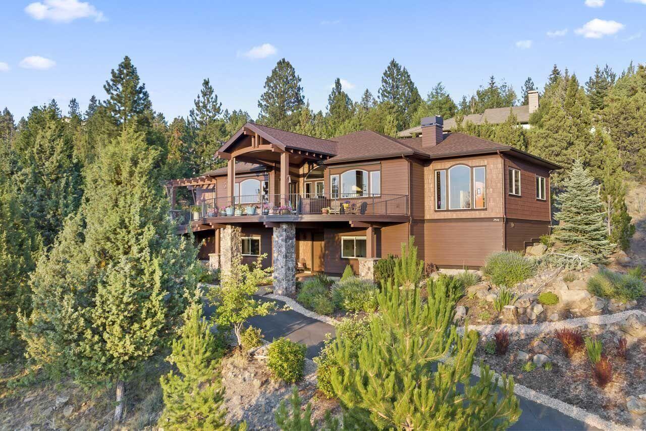 Best Views in Bend!!! You can't pass up the opportunity to see these views! This home was designed to showcase the Cascade Mountain Range from all the living spaces. Imagine cooking or dining while taking in the Three Sisters, or relaxing by the fireplace with Mount Bachelor in the distance.  If you want to get closer to the views, the covered deck offers heaters and a large fire pit to relax the evenings away. The main floor has gorgeous wood cabinets and warm Acacia flooring, with the Luxurious Primary Suite and two additional offices or bedrooms.  Downstairs, you'll find two additional bedrooms, a family room, and an exercise room.  And don't forget the awesome amount of storage. This home has it all (heated driveway, Three-car garage, accessible living, generous half-acre lot) and is located within a short distance to all the Westside offers (Restaurants, Shops, Schools, Trails, Golf, Tennis). Come visit this Awbrey Butte paradise, and experience summer living at its best!