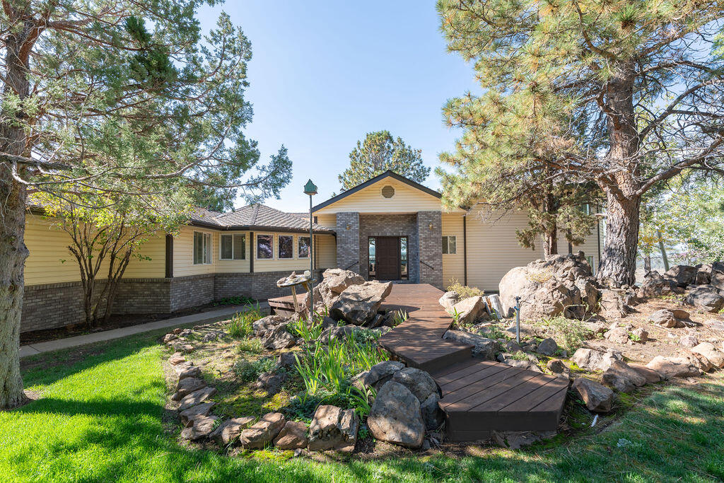 Just 20 minutes from Bend, this 3077 sqft home  on 2.52 acres offers breathtaking Cascade Range vistas. Built in 1992, the home features 3 bdrms, 3 baths + powder. Living, dining & kitchen areas are framed by large windows showcasing sweeping mountain views. Kitchen includes tile counters, double wall ovens, microwave, dishwasher, refrigerator & extended island - ideal for entertaining! All major appliances; refrigerator, washer, dryer included. Front & rear yard are fully fenced, with mature trees & sprinkler systems. Property includes 3-car garage, detached shop & RV bay. Expansive rear deck runs full width of home, delivering panoramic views & a tranquil outdoor living space. Combining country peace with accessibility- close to Bend, hospital & shopping - it's a rare opportunity!