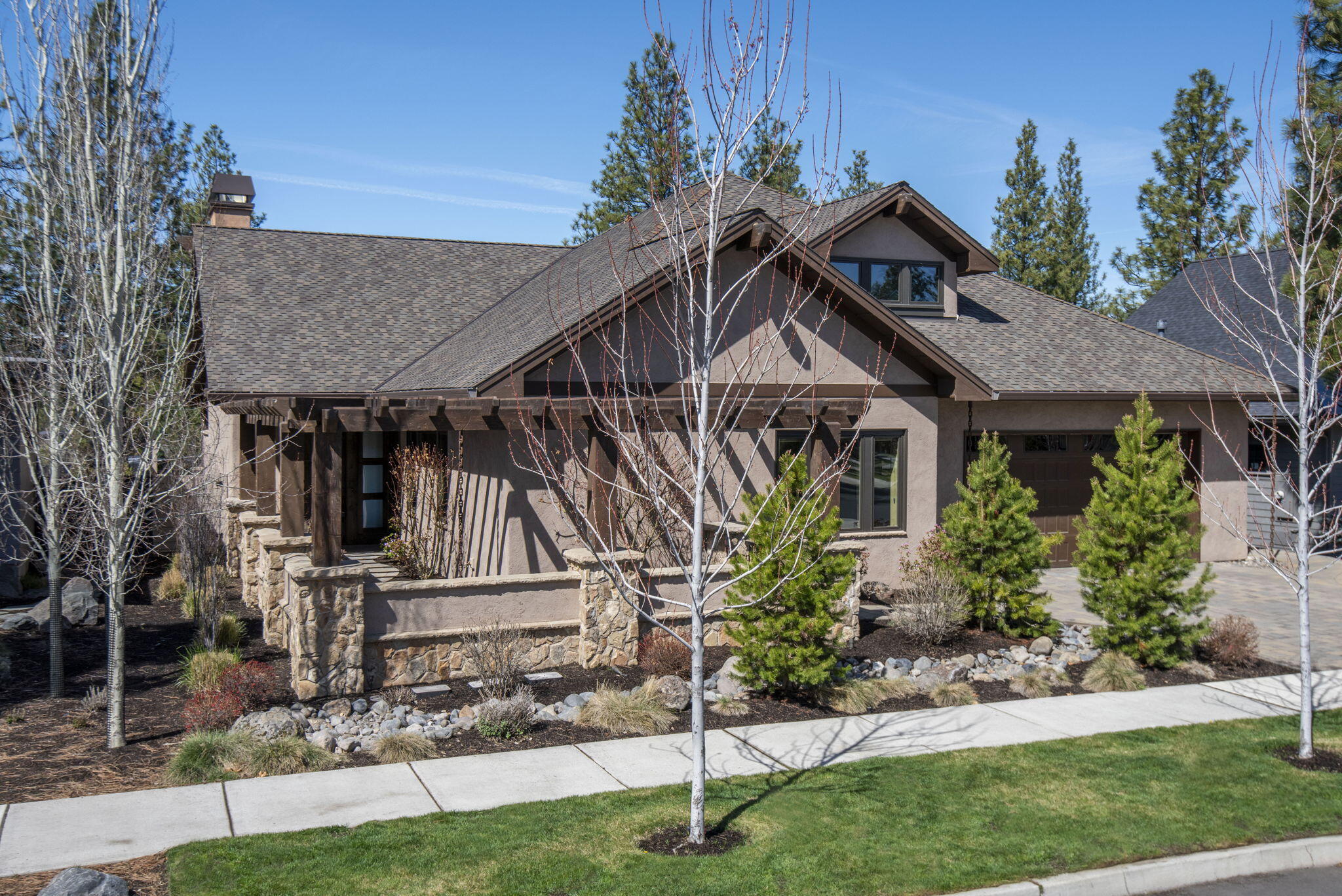 This single-story masterpiece offers the perfect combination of luxury, comfort, & breathtaking mtn views w/ expansive windows that fill the home with natural light & warmth. The vaulted open beam ceilings give a slightly rustic feel w/ sophistication. Entertain w/ ease w/ Wolf kitchen appliances in the open living space + outdoor kitchen and gas firepit that provide the perfect setting for patio dining against the backdrop of stunning sunsets over the Cascade peaks. Each bedroom offers its own ensuite bathroom & walk-in closet. Need a space for work or storage of all your Central OR toys? The temp-controlled lock-out room attached to the 3-car garage is great for a private workspace or storage. The home is near Shevlin Park trails so as to experience the ultimate outdoor lifestyle. It's designed for maximum enjoyment w/ minimum maintenance. If you're looking for a larger yard, the adjoining lot is for sale in addition to the home, a .20-acre lot of untapped possibility & longer views