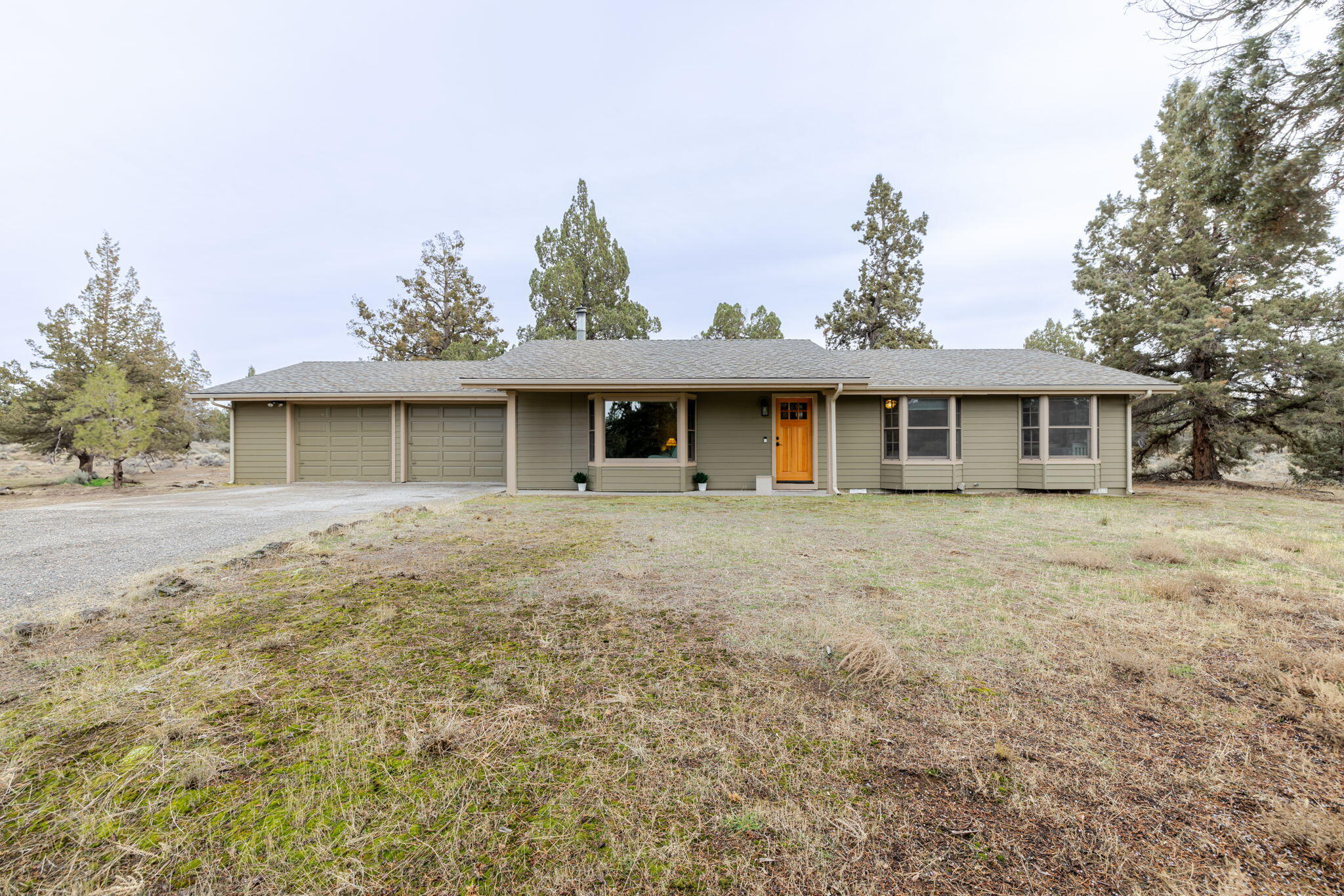 Discover peace and privacy in the desirable Boonesborough neighborhood with this hard-to-find single-level ranch on 2.45 serene acres surrounded by majestic old-growth junipers. this 3 bed, 2 bath home offers an open living/dining layout and an updated kitchen with great natural light, ample storage, bay window, soft-close drawers, under-cabinet lighting, hands-free faucet, plus a 2-car garage. The primary suite features a walk-in closet and French doors to the private backyard. The level acreage with a private gravel driveway provides exceptional tranquility, RV/boat parking, and space for a future shop/barn. Recent upgrades include a new kitchen upgrade, newer roof, Hardie siding, windows, doors, wood flooring, updated closets, and A/C. A perfect blend of nature, comfort, & convenience—don't miss this Central Oregon gem. Ideally located near the Bend Airport, the new Costco, shopping, dining, trails, & quick highway access, this property blends tranquility w/ everyday ease.