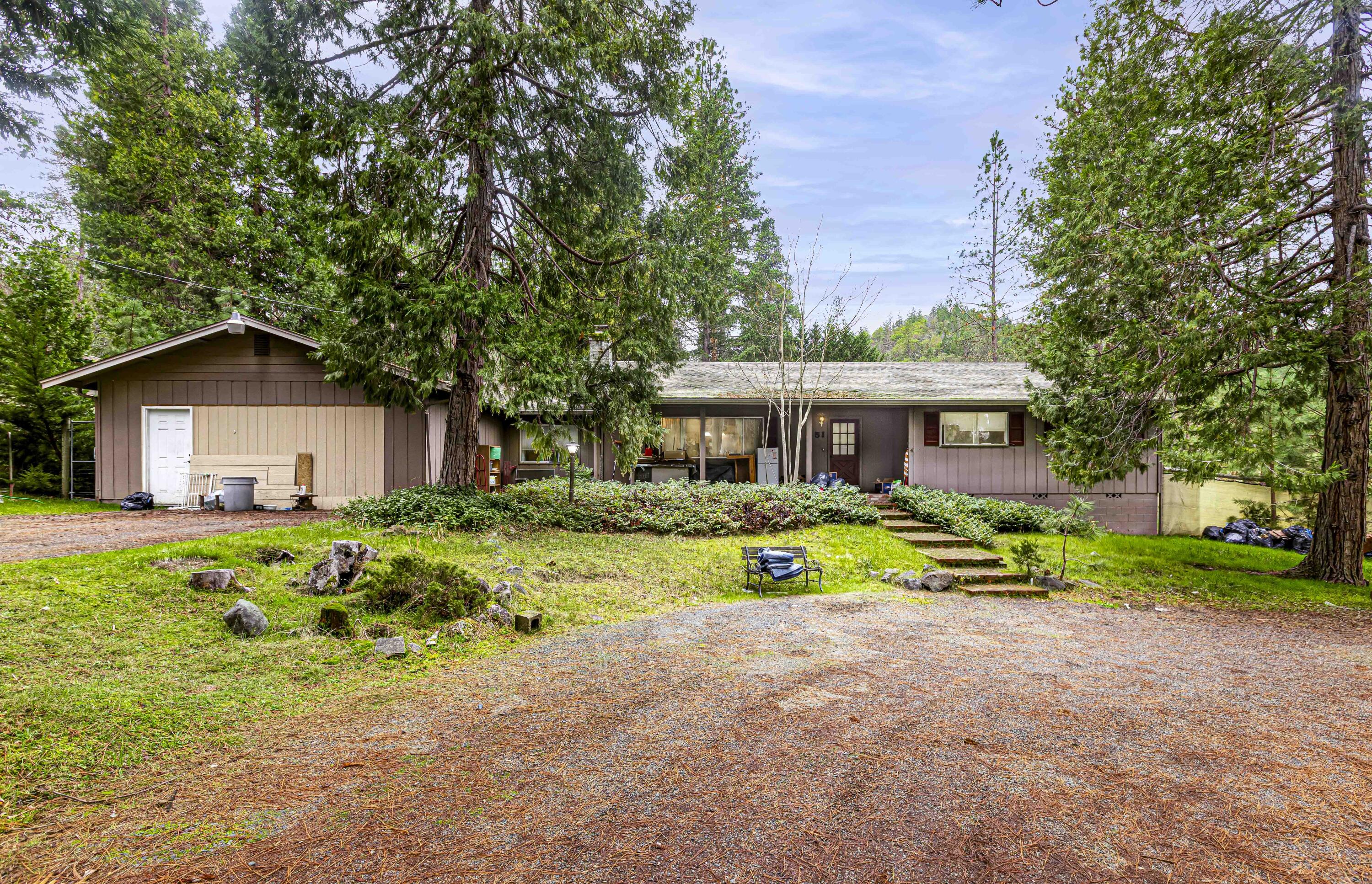 Bring your imagination, elbow grease and vision to this 3-bedroom 2-bath home and give it a new life. Absolutely fantastic neighborhood with mature trees , gardening areas , room to roam for children and fenced. Unlimited potential for redesigning inside - open spaces - Large floor plan. A stone fireplace greets you in the living room, while the kitchen Bankette offers a place to sit and chat while dinner is being prepared. The huge family room off the kitchen offers plenty of space for entertaining. A bonus room and even a space for an office give the home even more opportunity for your creativity. In need of some fixing and updates, this home has the potential to be a forever home. The mostly flat, nearly 1 acre slightly sloped property features a lovely gazebo and room for the chickens in the large coop, and more storage in the 2 sheds.
The garage is being remodeled into more storage space but could easily be converted back to a 2-car garage.