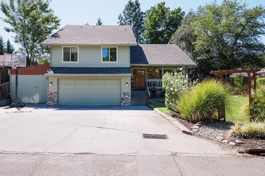 This comfortable East Medford home on .38 acres features a beautiful pool with palm trees, room for RV parking (and your other toys!). Main home offers 1,830 sqft with 3 bedrooms, 2 baths, family room, living room and formal dining room. Vaulted ceilings throughout and large master bedroom. Kitchen is light, bright and boasts new vinyl flooring - complete with Jen-Air range/oven and dishwasher, wine refrigerator and plenty of counter space. Additional 625 sqft dwelling unit is plumbed for a kitchen, currently used as theater room; entertainment center, TV and six theater chairs included. Large backyard with deck and covered patio, putting green, and a custom gazebo with fan/ light combo offering ideal shade. Pool is run by computer system with underground speaker and lighting throughout pool area; set up for solar though seller never installed. Perfect home for sun-soaked entertaining during the day and elegant, moonlight ambiance at night. Main house is not directly on Sunrise, pool h