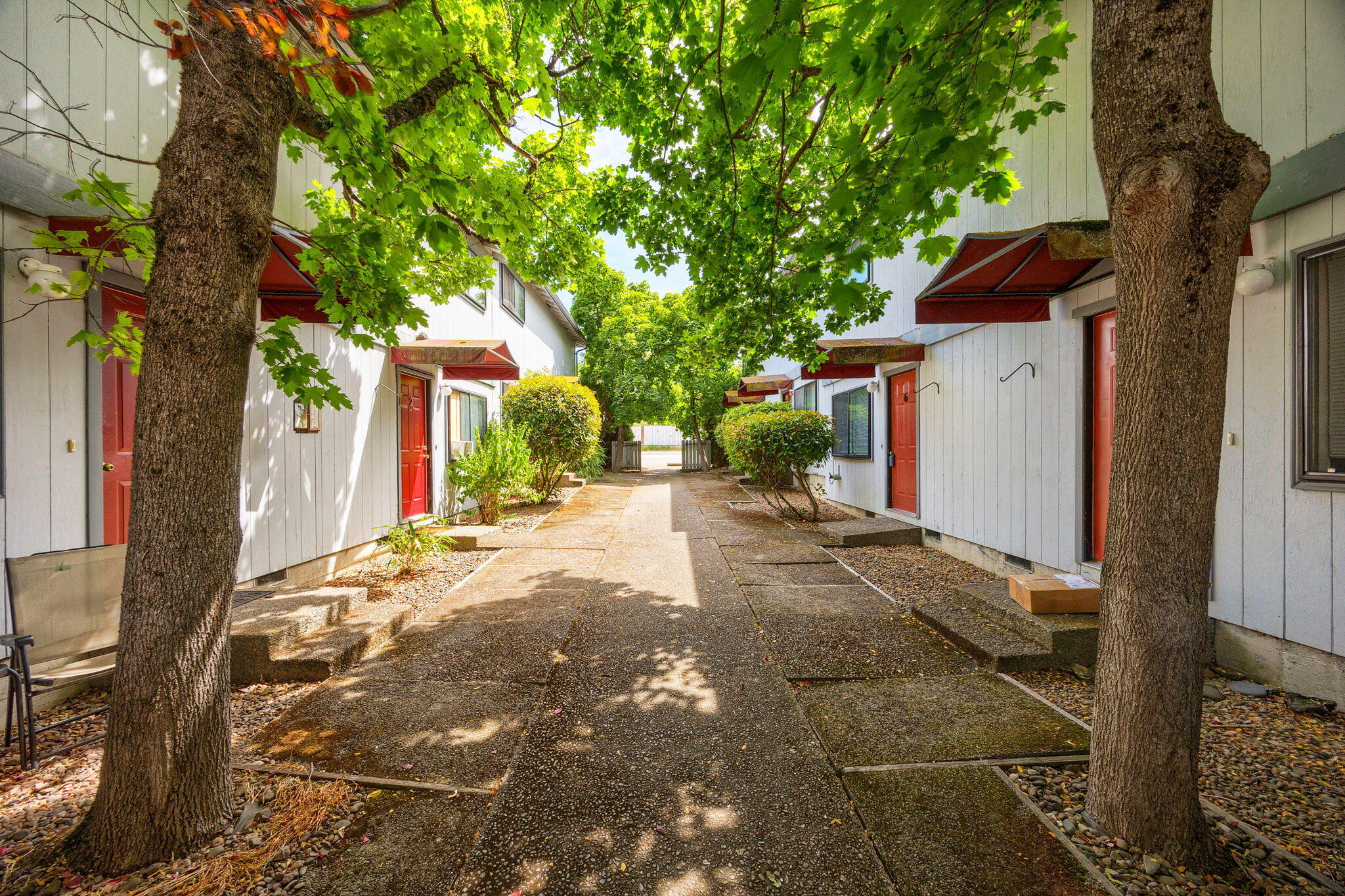 Ideal location in the heart of Ashland. Railroad district eight plex. Townhouse-style two-bedroom one and-a-half bath 850 sq ft apartments. Well-maintained units feature kitchens with granite countertops, forced air heating, and private patios. Common courtyard area and off-street parking. Close to the plaza and the university. Two separate tax lots for ease of financing.
