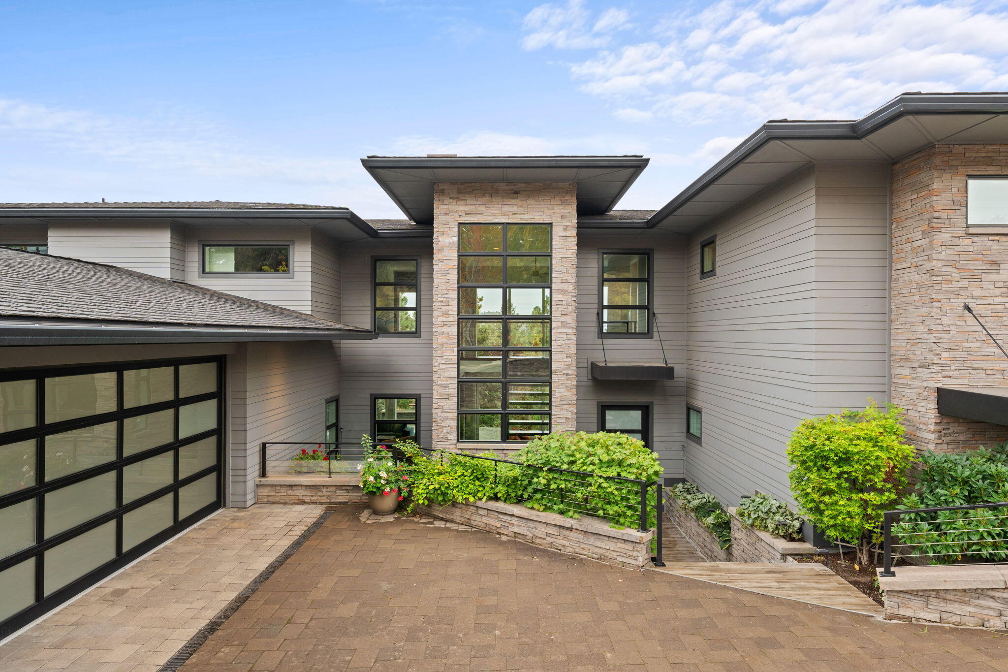 Welcome to this stunning retreat perched above the Rivers Edge Golf Course on highly sought-after Awbrey Butte! A striking front elevation in the beloved Prairie style, inspired by the visionary Frank Lloyd Wright, leads to a front entry with a serene, soothing water feature. Spanning an impressive 4,000 sq. ft., this home is designed for gatherings with modern finishes that create a perfect canvas for your vibrant art collection. Lofty ceilings and carefully curated lighting, will allow every piece to shine. The thoughtful layout includes a primary suite upstairs, along with two bedrooms downstairs, making it an ideal choice for multigenerational living. The heated driveway leads seamlessly into a spacious two-car garage equipped with ample storage and an epoxy floor. Outside, a party patio awaits, where you can grill, relax & enjoy picturesque views of golfers below—perfect for entertaining! This private oasis feels like a luxurious retreat, offering the ultimate in comfort & style.