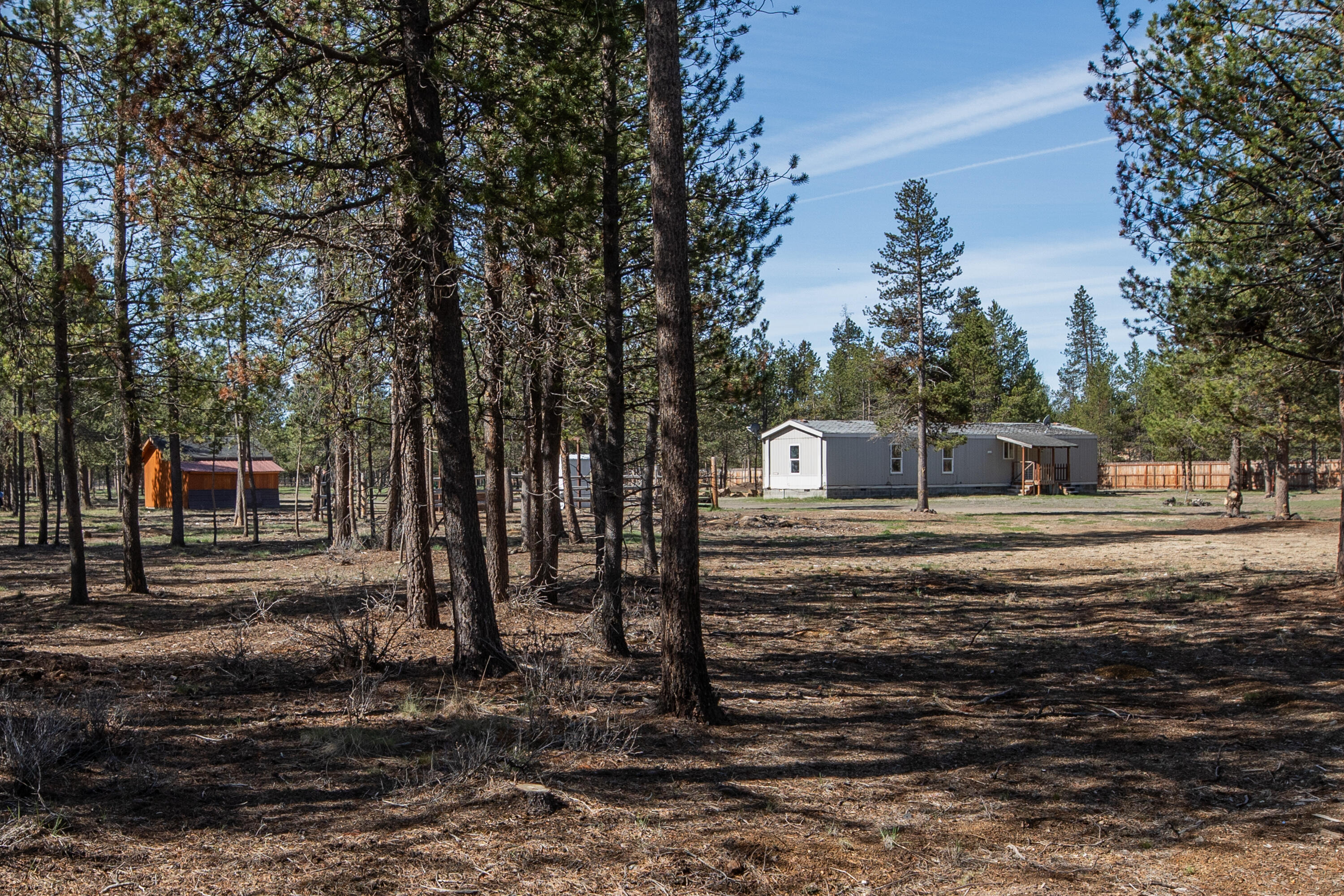 Rural living 8 miles from La Pine out in a private and quite wooded area. Whether you're seeking a homestead, a recreational retreat, or an investment opportunity, this one has the bones and the setting to make it shine, offering a fresh opportunity for redevelopment.  The 3 bdrm/2 bath 1999 manufactured home has no stated value. This unique 5 acres is quiet and the perfect country setting that adjoins BLM land allowing you to ride your horse right out back, though the woods. The property is perimeter fenced making it ideal for a horse or other animals. Wildlife is abundant. The cozy rustic bunkhouse sleeps 4 making it a getaway retreat to enjoy lake fishing, hiking or hunting. Key improvement, the wildland fire hazard mitigation has been completed. All the essential utilities are in place; well, septic, and electricity. Seller is a licensed real estate broker in the state of Oregon.