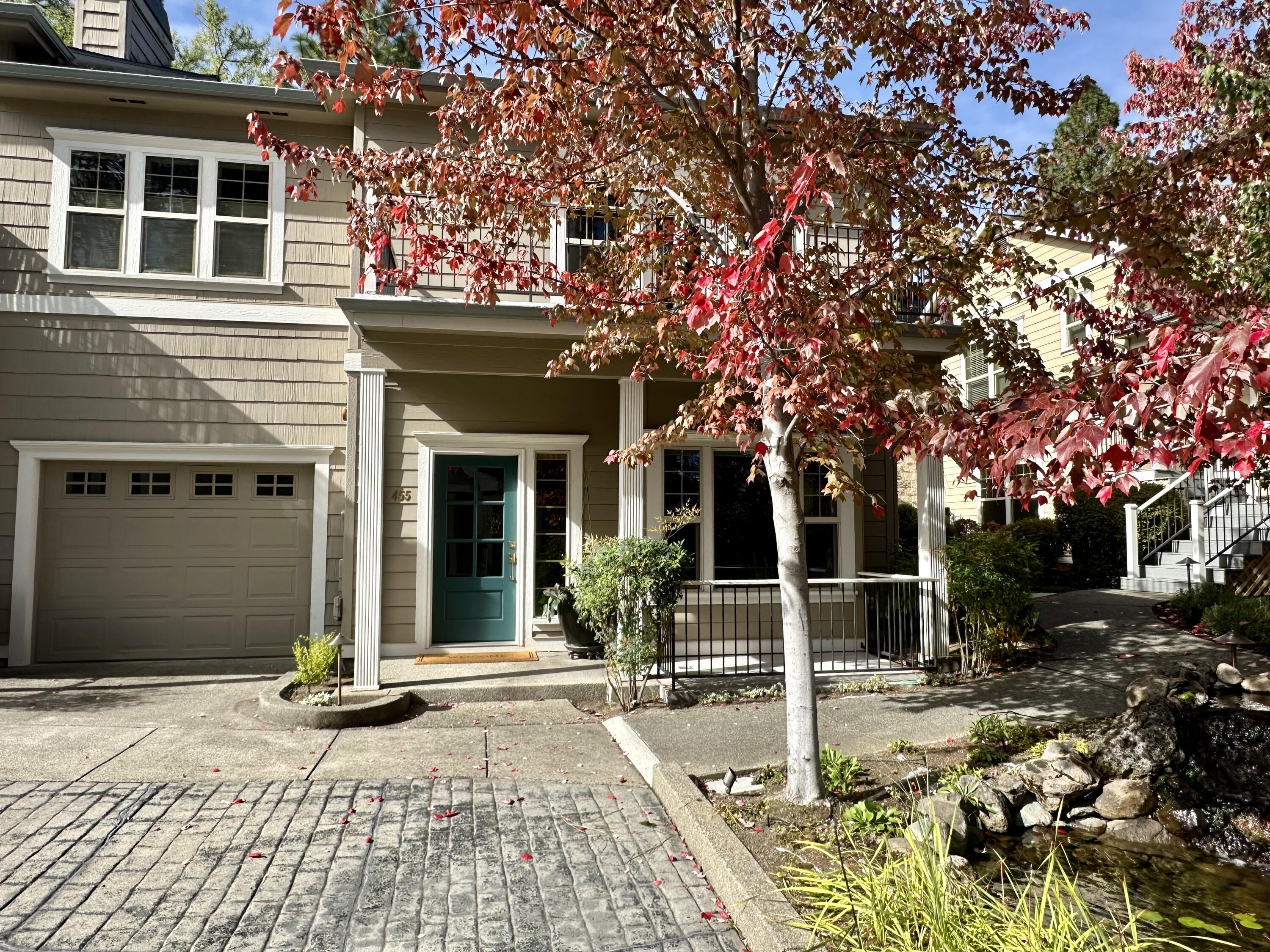 Beautiful Highland Pines townhome in a quiet neighborhood just above downtown Ashland! This 3 bed, 2.5 bath end unit offers 1,844 sq ft of light-filled living with custom touches throughout. Enjoy high ceilings, engineered wood floors, gas fireplace with wainscoting, and serene mountain views. The kitchen features Corian counters, two pantries, solar tube, new dishwasher, and under-cabinet lighting. Primary suite includes a view balcony, walk-in closet with custom organizers, blackout curtains, and jetted tub. Additional highlights: renovated powder room, wool carpet, Nest thermostat, updated lighting, built-in speakers, solid mahogany door, USB charging outlets, and fire sprinklers. Private fenced patio, spacious staircase, oversized single garage, and well-managed HOA complete this move-in ready home in one of Ashland's most sought-after communities.