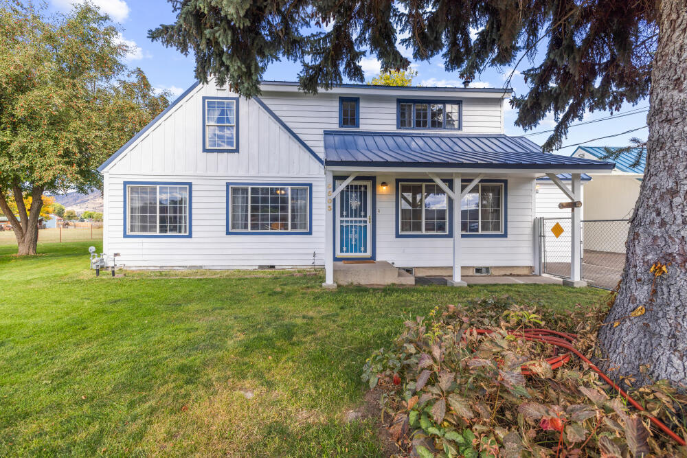 This spacious 2,281 sq.ft. home sits on a 1.10 acre lot with endless possibilities. Inside enjoy 3 bedrooms, 2 bathrooms, plus a bonus room that could be converted into a 4th bedroom. A screened-in porch is perfect for year round relaxation, while a cold room offers extra storage or utility space. Freshly painted, the home is move-in ready. An oversized two-car garage with attic space offers room for vehicles, tools, or a workshop. Outdoors, the property features EID irrigation with underground lines, and six faucets, making it easy to maintain gardens, pasture, or landscaping. The large lot is ideal for keeping animals, raising chickens, or hobby farming, and may also be split for building another home or investment property. With comfort, flexibility, and room to grow, this property has it all- Schedule your showing today!