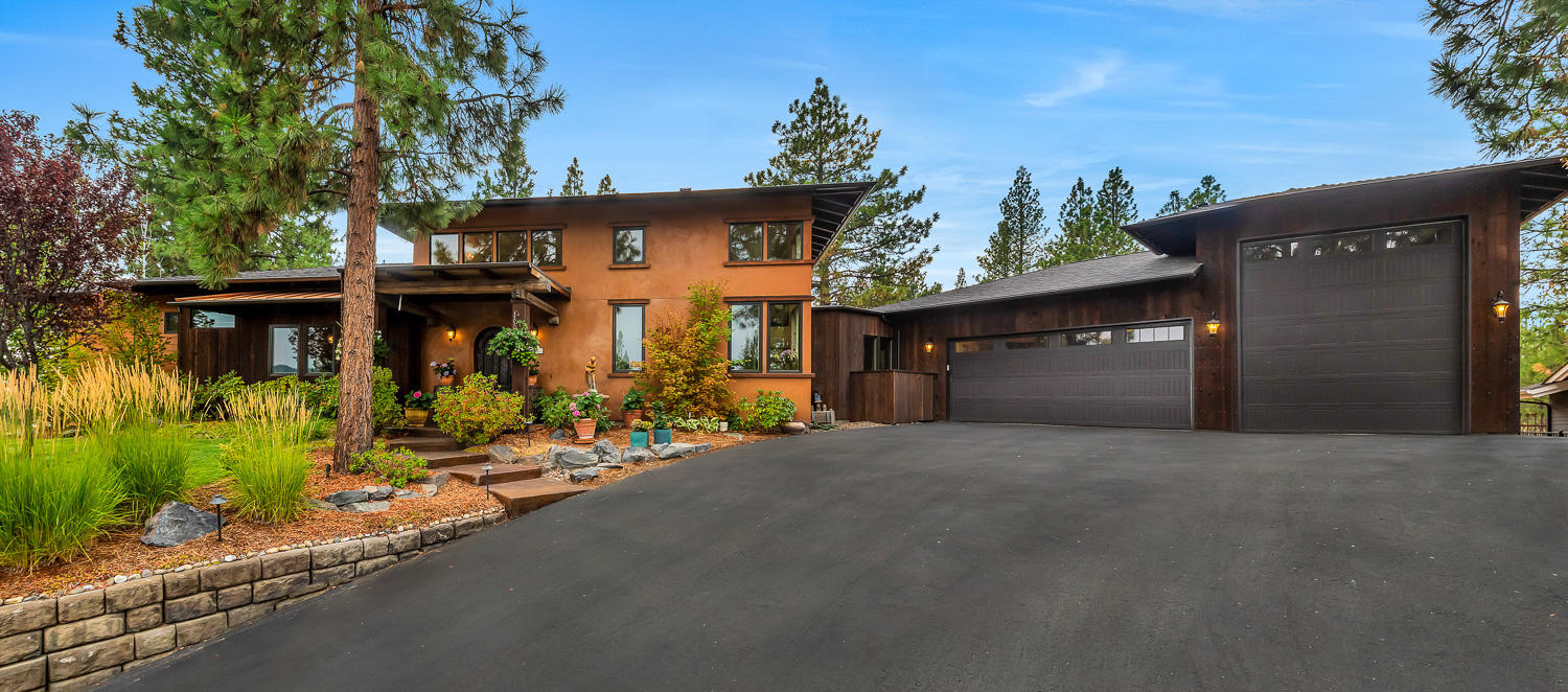 This artistic & eclectic Shevlin Ridge custom home seamlessly blends outdoor living with the charm of an Italian farmhouse. Exceptionally private .40 acre lot with serene views of Awbrey Butte & the Paulinas. Easy access to trails, parks & Westside amenities. Open & airy great room with loft, gas fireplace & charming kitchen furnished with live edge quartzite counters, oversized island, DCS 5 burner range, copper & travertine sinks. Dining area flows smoothly through French doors to a backyard oasis with timber framed cover for BBQ & Italian wood-fired pizza oven, garden beds & a hot tub. Primary suite opens directly to the concrete patio & pergola covered seating area & features 10' ceilings, defined office space, bath with travertine floors, dual head shower & two vanities. Unique details abound from reclaimed posts & beams to vintage hardware & repurposed doors. 3 car garage includes 35' RV bay with 12' door plus rooftop solar; just a few of the surprises awaiting you here!