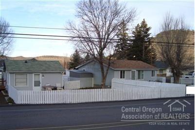Great investment property with several possibilities. This offers the opportunity for rental income or residence with guest quarters or both. 2 homes on 1.15 acre lot. 1 home is a 2 bed, 1 bath residence. The other is a 3 bed, 2 bath manufactured home. 980 sqft shop that has a small guest quarters inside - living room and bath downstairs with a bedroom/closet space above shop floor (loft). Shop with loft is approx 1288 sqft.