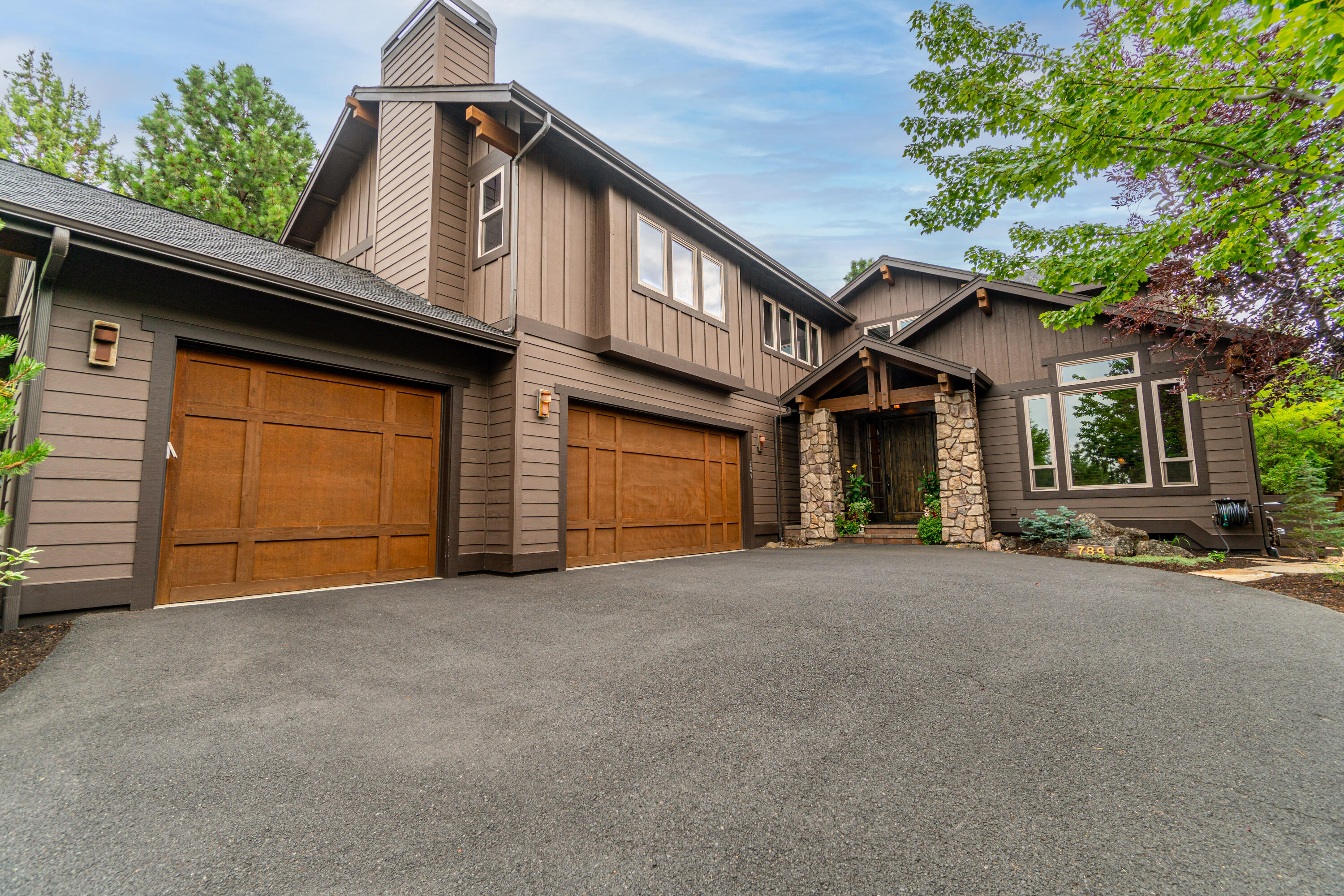 Located on a peaceful, tree-lined street in the sought-after community of Awbrey Park, this home offers privacy, space and exceptional design throughout. Great Room features soaring ceilings, light-filled windows, hw floors and dramatic stone fireplace. OUTSTANDING Chef's kitchen w/solid surface countertops, expansive bar, prep sink, walk-in pantry and SS appl including built-in refrigerator, dbl ovens, and wine fridge. Spacious Dining area overlooks lush gardens and offers direct access to backyard and patios for easy al fresco dining and entertaining. Main level Home Office. Upstairs: Primary Suite w/access to private upper deck and spa-like BA w/soaking tub, tiled shower and dual vanity. 2 add'l BR and full BA on 2nd level, loft flex space + FANTASTIC Bonus Room w/gas fireplace. Charming backyard w/mature foliage provides excellent privacy and offers multiple outdoor spaces to enjoy year-round. 3 car garage for all your Bend gear. Close proximity to Westside schools and River Trail.