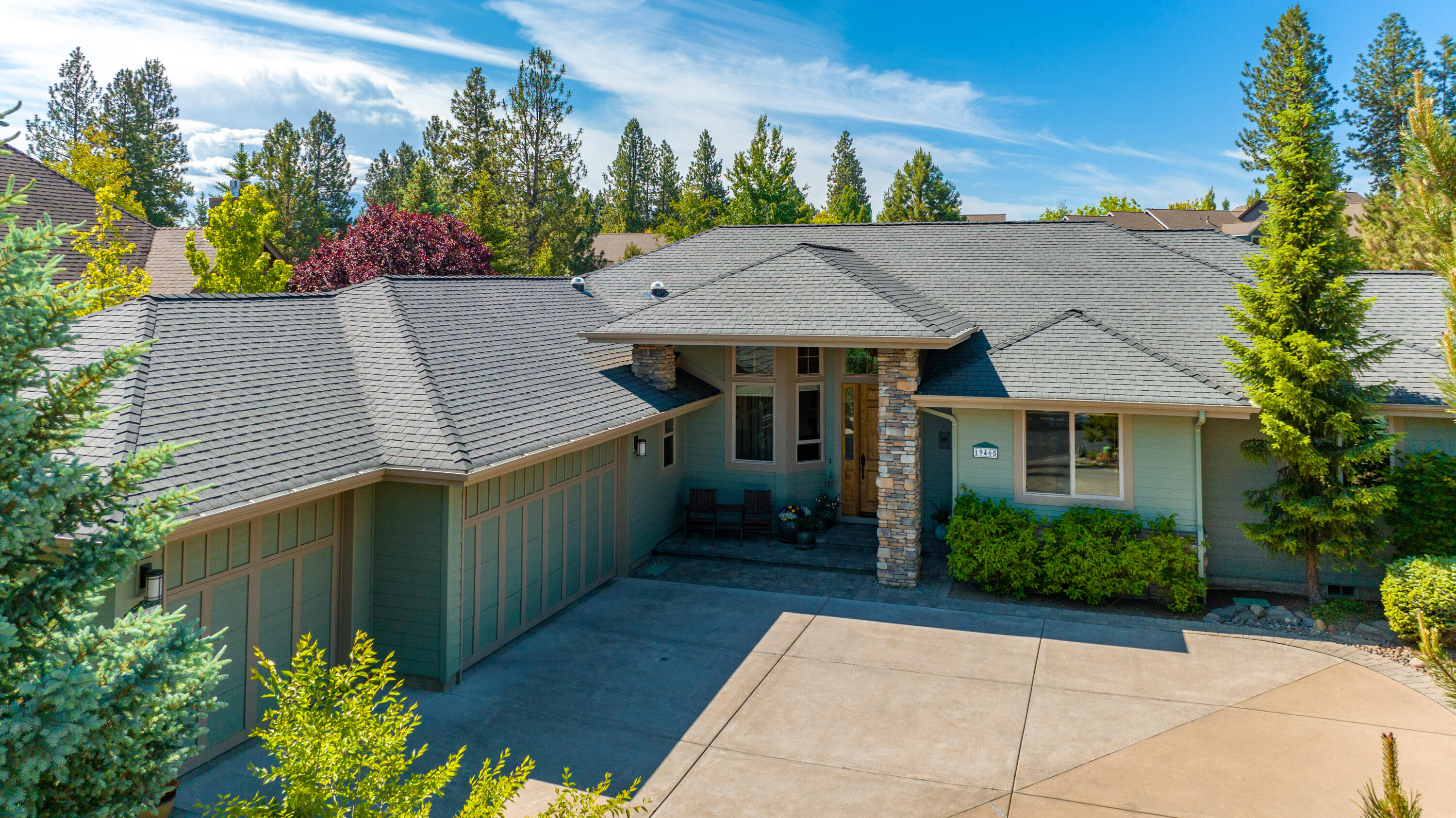 Built by Schumacher Construction, this stunning residence showcases meticulous attention to detail and exceptional craftsmanship. Located in the highly sought-after community of RiverRim in SW Bend, this single-level home offers nearly 2600 sq. ft. of thoughtfully designed interior space on a 1/4-acre lot. The east wing features a primary bedroom with a spacious en suite bathroom and walk-in closet. The west wing includes a junior suite, a second guest bedroom, full bathroom, bonus room, and office. The heart of the home revolves around the great room and kitchen, seamlessly connecting the living and dining areas. The charming dining nook overlooks the captivating outdoor living area, protected by beautiful mature plantings, a water feature, and raised beds. Situated alongside the beloved neighborhood green space, the rear of the property enjoys abundant sunlight and exceptional privacy. Rounding out this offering is a three-car garage and a rarely found radiant heated driveway.