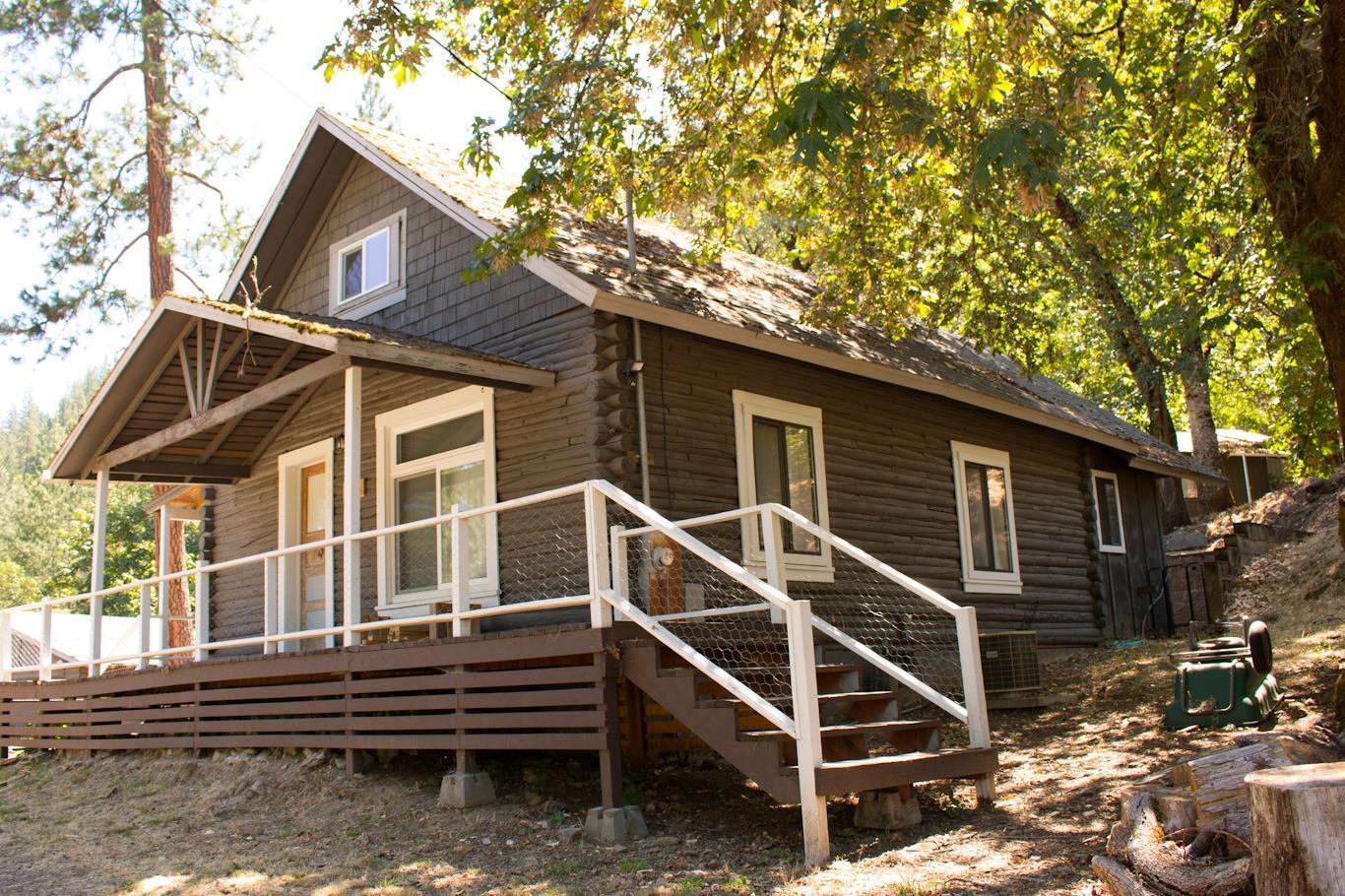 Back on market to no fault of the property! This home is not a drive by, you will miss out on all of the charm and beauty that this home and property have to offer. Just a short drive off of I-5 this Grants Pass home is actually in Jackson County. The log cabin has seen many upgrades over the years; 5 year old Blaze King wood stove, new flooring and stylish wall treatments. As well, the attic conversion includes a newly finished bathroom and a large adjoining room. Outside you have extended living space to the detached shop. This building can be used as a studio as it has finished walls and flooring. The 2-car garage allows additional space for your vehicles, toys, and hobbies.