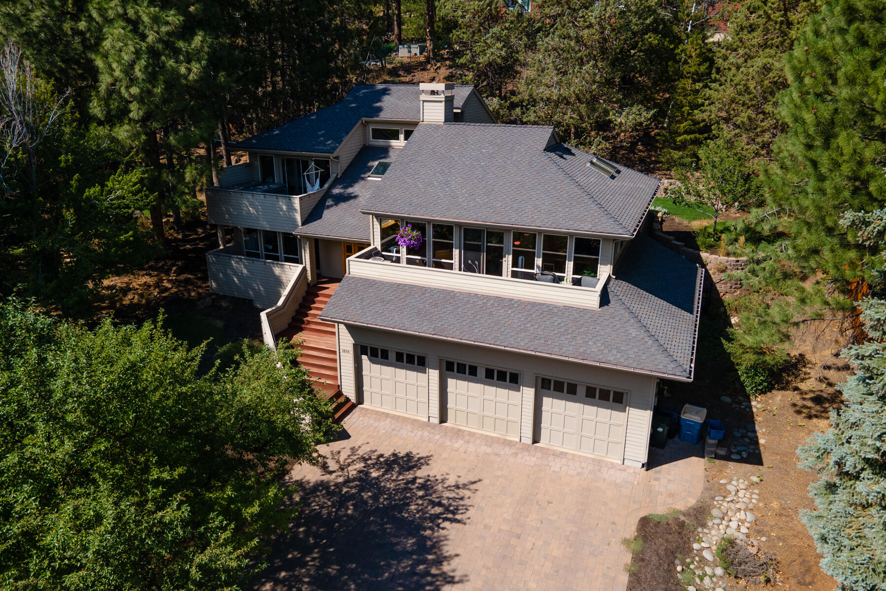 Take in the city views from this beautiful West Hills home in Bend, Oregon. This three bedroom + bonus room, 3 bathroom home has high end custom finishes throughout. The gourmet kitchen has a subzero fridge, wolf oven/range, and granite counters. Multiple decks on both the front and back of the home allow you to take in the views and enjoy the mature landscaping. The 3 car garage offers 1,197 sqft of heated space.