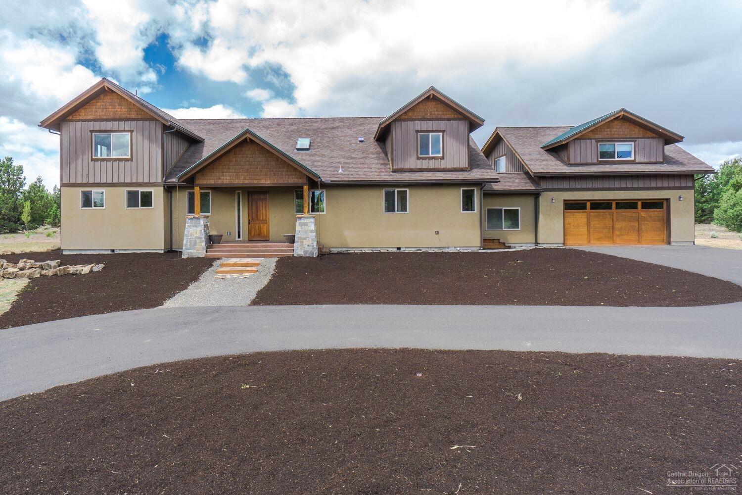 Custom built entertainer w/mstr on the main. Features 4bds/3bth,loft and bonus rm Walk-in to find NW styling throughout w/soaring ceilings, extensive wood work, floor to ceiling stone fireplace, rot iron, floating 2nd floor hallway, mountain views & a natural setting in the back half of the acreage. Property backs to canal. Newly seeded grass pasture. Oversized garage w/ additional heated bonus/game room. Separate 3 bay garage/shop one bay for RV parking. Mt views, RV Garage, Shop, Loafing shed, and more.