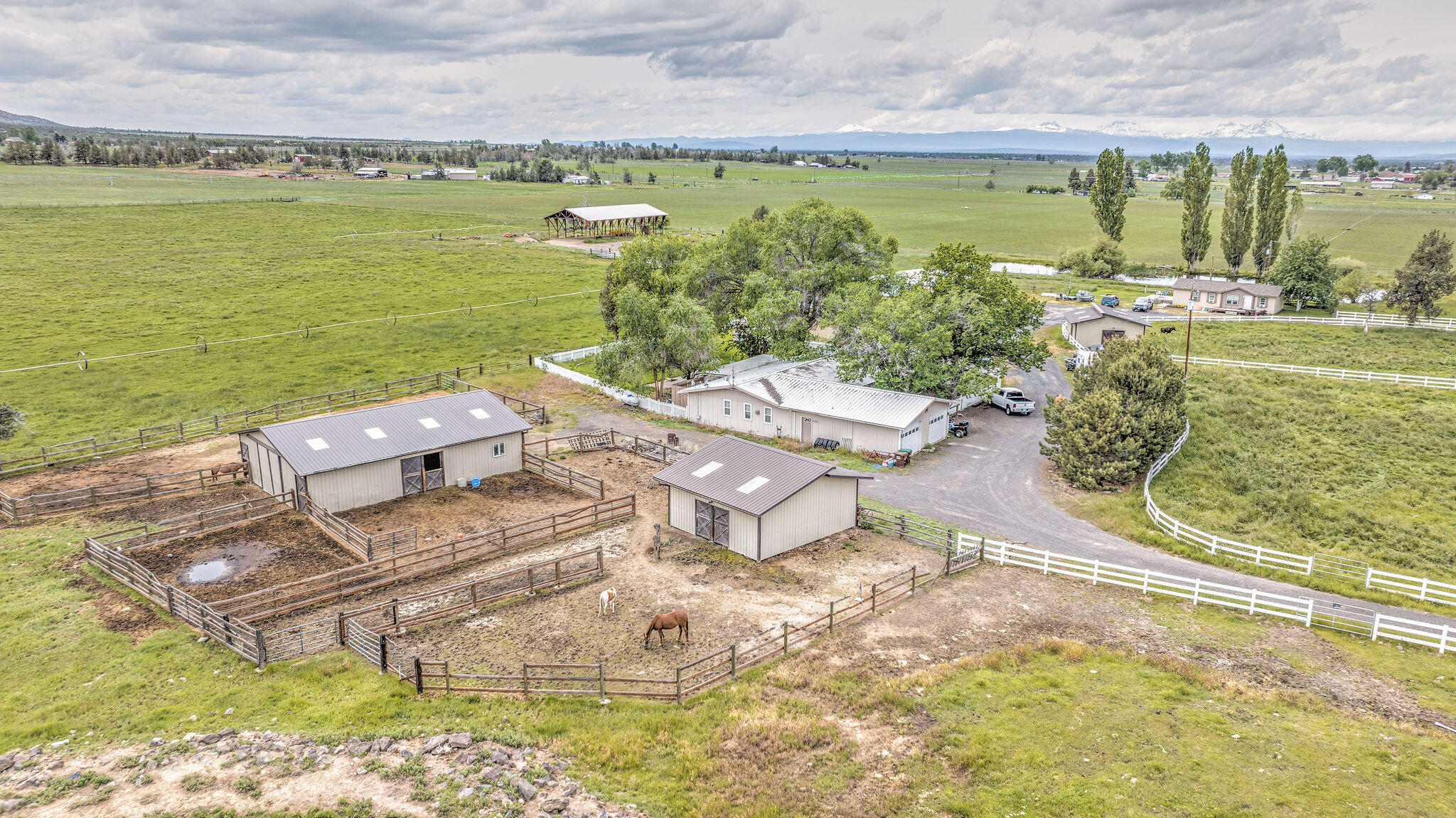 77.6 acres of excellent farm, with 2 homes, 66.98 acres of irrigation, & all the necessary improvements. With rental income opportunities & excellent hay production, this small ranch has a lot of upside! Irrigation equipment includes a new 30hp pump for the 3 wheel lines. 2 of these wheel lines irrigate approx 36 acres of orchard grass. The approx 40 acres of pasture are irrigated with a combination of wheel line, hand line & flood. The pressurized system is all buried main line. This property feature 3 ponds for irrigation & stock water. The main single level home is a spacious 2,560 sq ft with 3 bedrooms/2 bathrooms. The second home is a 2013 manufactured home, featuring 1296 sq ft and 3 bedroom/2 bath. Additional improvements include a large hay cover, machine shed, 2 horse barns w/stalls, runs & tack storage, nice shop, machine shed, & hay barn. All this with a convenient location, Cascade Mountain views & amazing country living.
