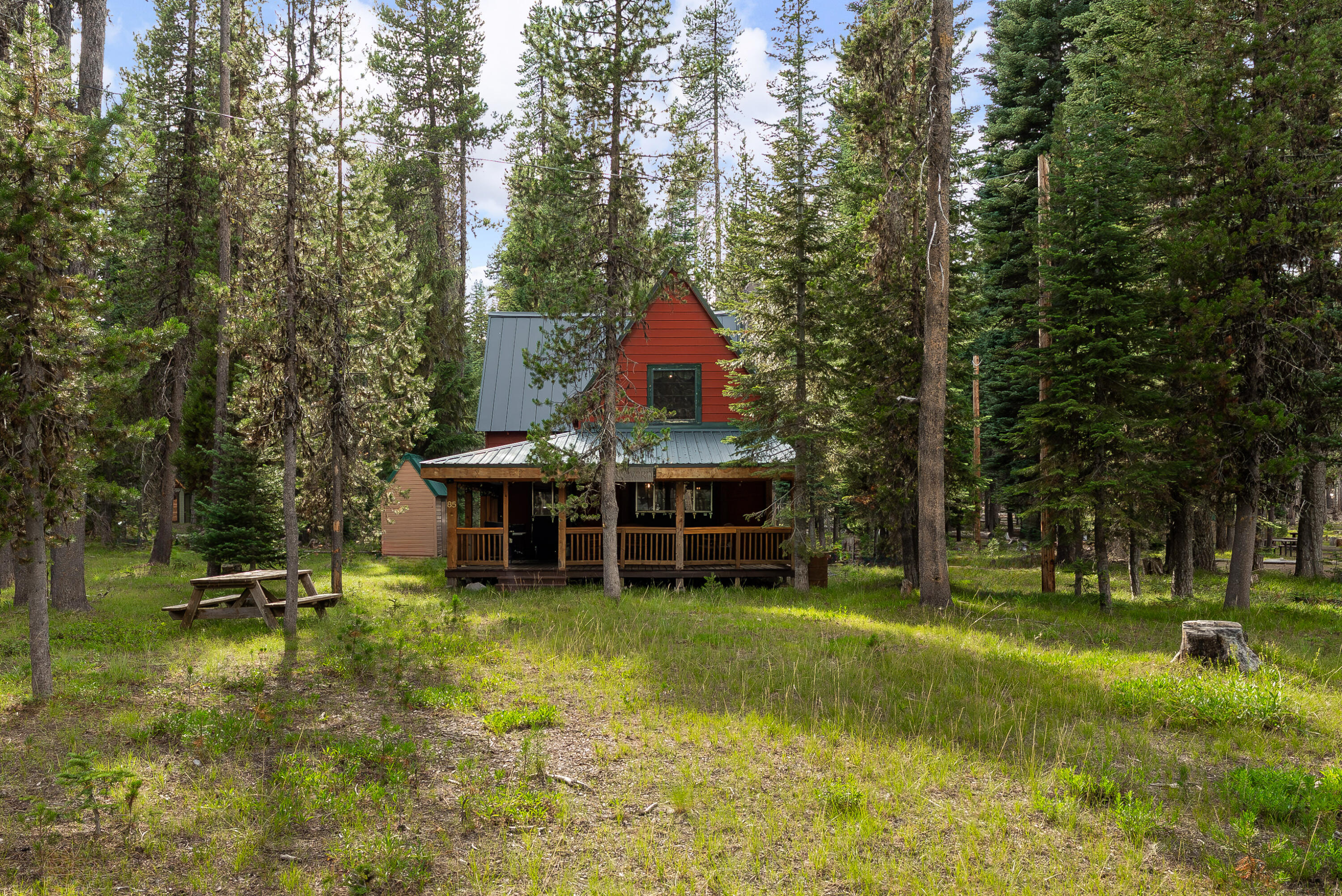 Tucked in the trees with a filtered lake view, this Diamond Lake cabin offers year-round adventure and cozy retreat vibes. Whether you're fishing at first light, cruising the lake, or snowmobiling in the winter, this place makes it easy to unwind and recharge. The large covered front porch is perfect for morning coffee or evening stargazing. Inside, enjoy a warm living space with wood stove insert, new upstairs electrical, new heaters, and a new panel. The roof was replaced 3 years ago, and the septic was pumped 5 years ago. Gas is no longer available, so the stove and water heater will need replacing—but with a full-price offer, the seller will provide brand-new electric replacements and include a 2014 Bennington 20-ft pontoon boat with trailer. A shared dock is available for mooring your boat. Cabins like this rarely hit the market. Here's your chance to own a piece of Oregon's wild beauty and start making memories that last.