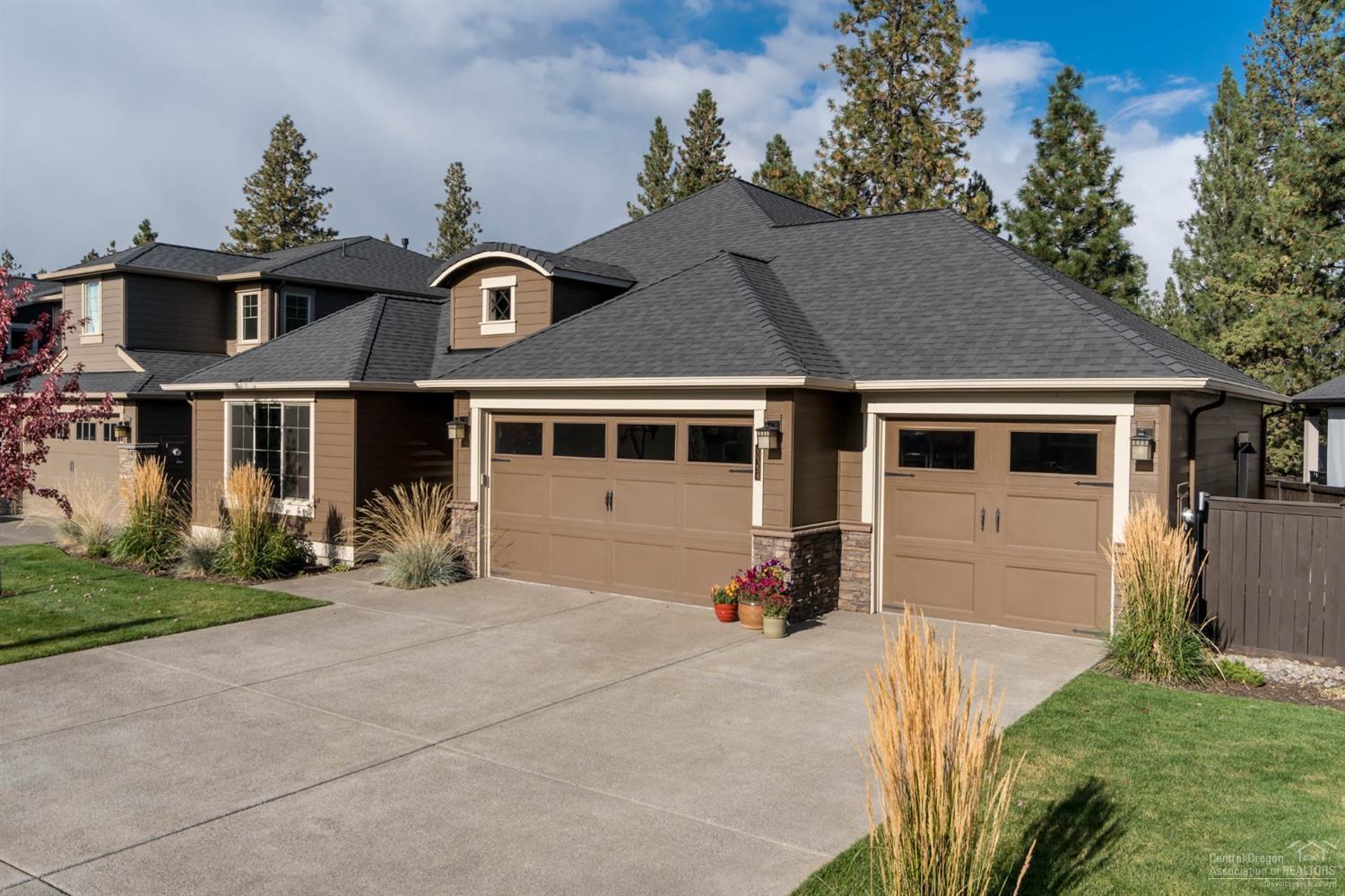 Single level living at its finest! Backing to natural common space, this home has room for all your Central Oregon toys! Formal entrance encompasses coffered ceilings & detailed stonework. Expansive windows throughout allow for an abundance of natural light. Quartz countertops, three car garage, new paver patio w/ raised beds, sink in laundry w/ built-in cabinetry, 2 masters. Wood wrapped windows, full tile backsplash. Pristine. Enjoy the neighborhood pool and resort style living this home affords.