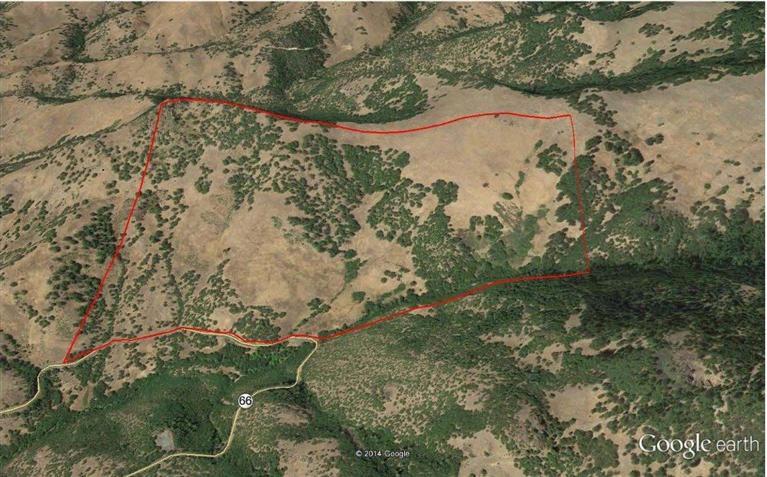 This property boasts large open grasslands and oak forest groves with south facing slopes that climb from the highway to Buck Point bluffs in the NW corner. The perennial Soda Creek and Hwy 66 make up the southern border near the existing homesite (which is expired but being renewed by the seller) and there is a live spring on the property near the access point which is located at the approximate 10 mile marker of Hwy 66 near Ashland. The property sits at 3000 feet in elevation. There are commanding views of Mt. Ashland and the Cascade Siskiyou National Monument from just about everywhere on the property.